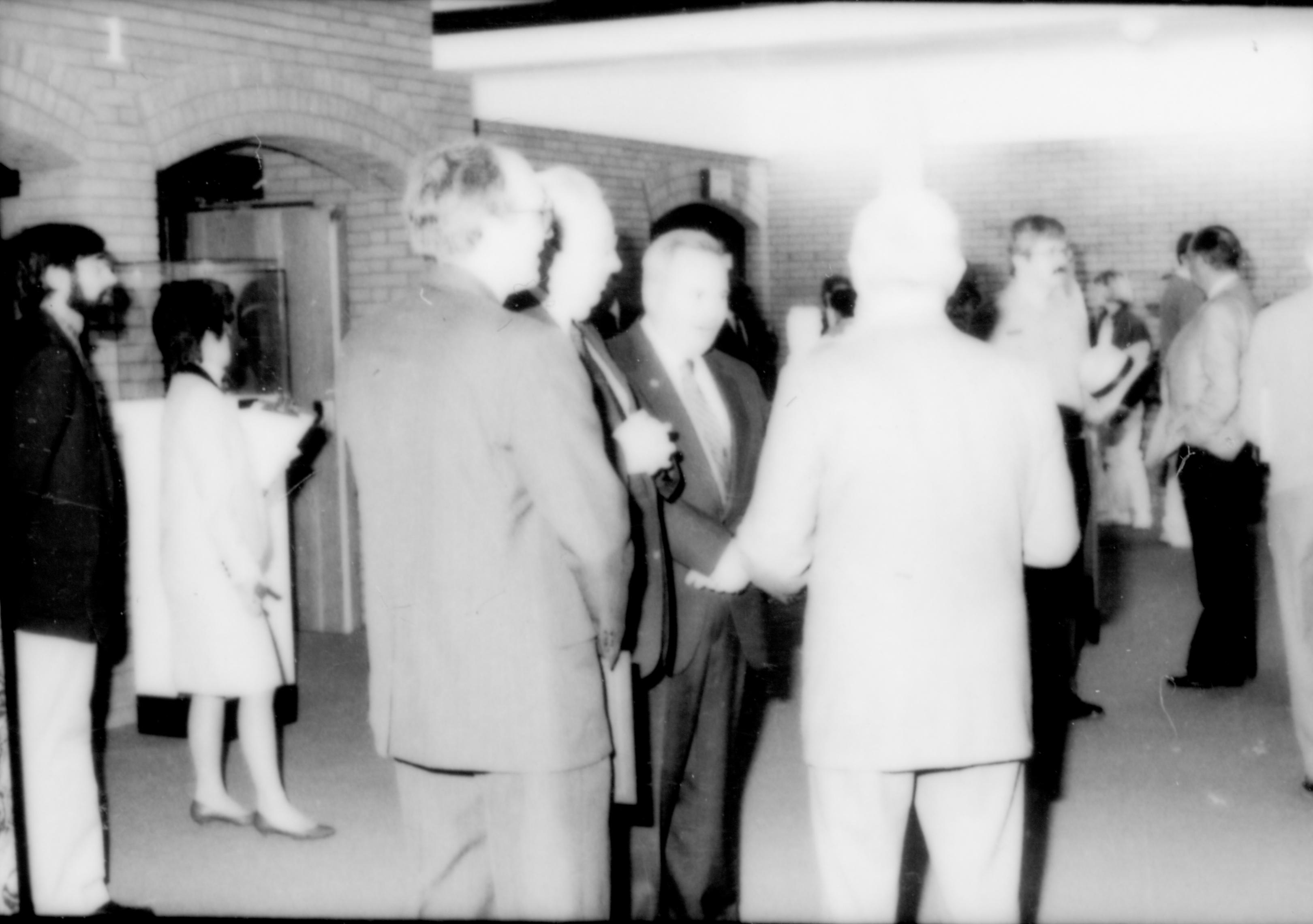 Group  of men standing standing, talking. Washed out. Lincoln Home NHS- Paul Findley and Michel VIP visit, 121 Finley, Michel, visit, reception