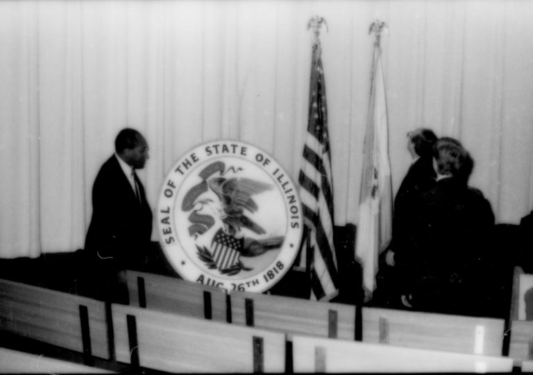 Man standing next to Ill. state seal. Lincoln Home NHS- Paul Findley and Michel VIP visit, 123 Finley, Michel, visit, reception