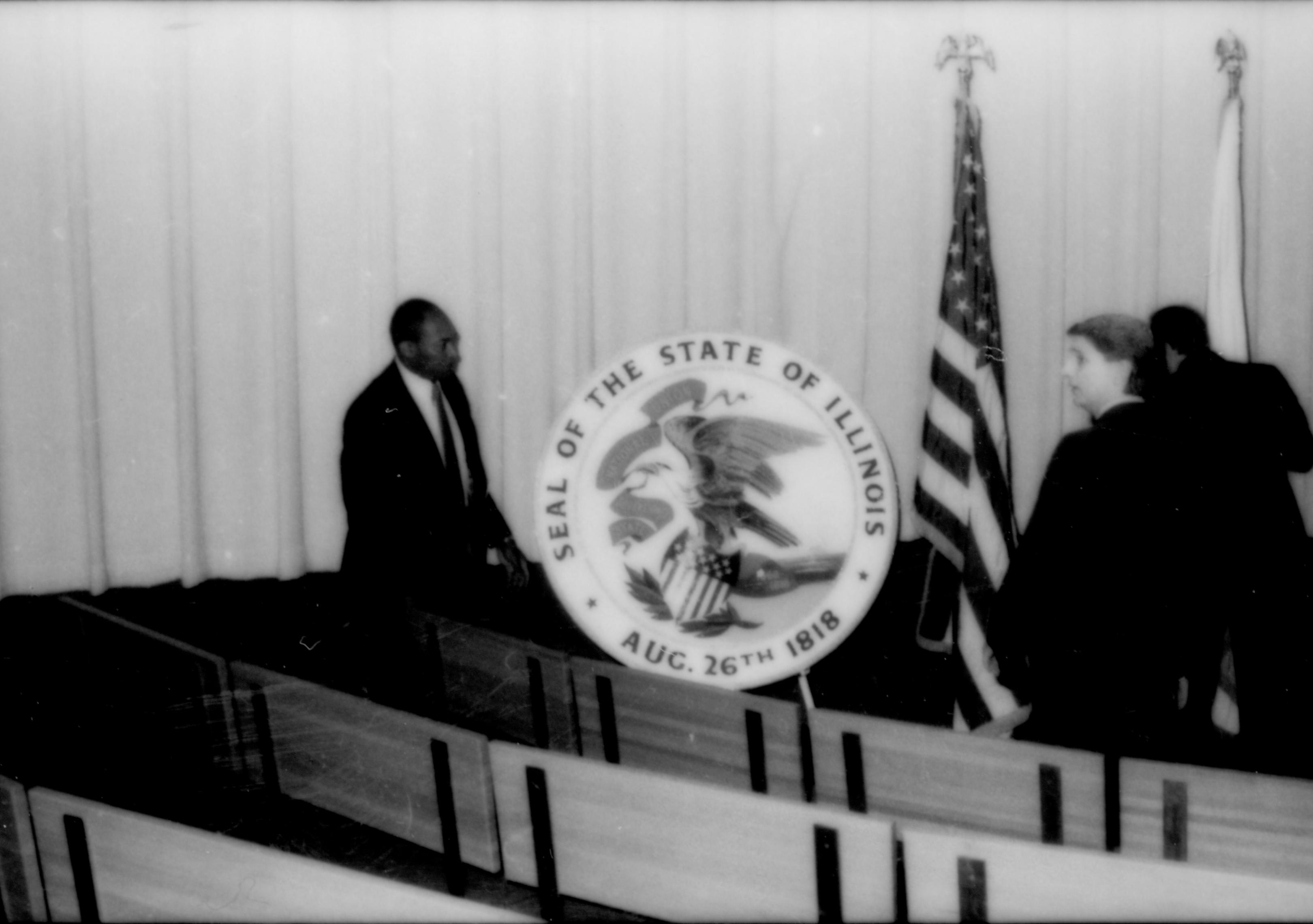 Man standing next to Ill. state seal. Lincoln Home NHS- Paul Findley and Michel VIP visit, 123 Finley, Michel, visit, reception