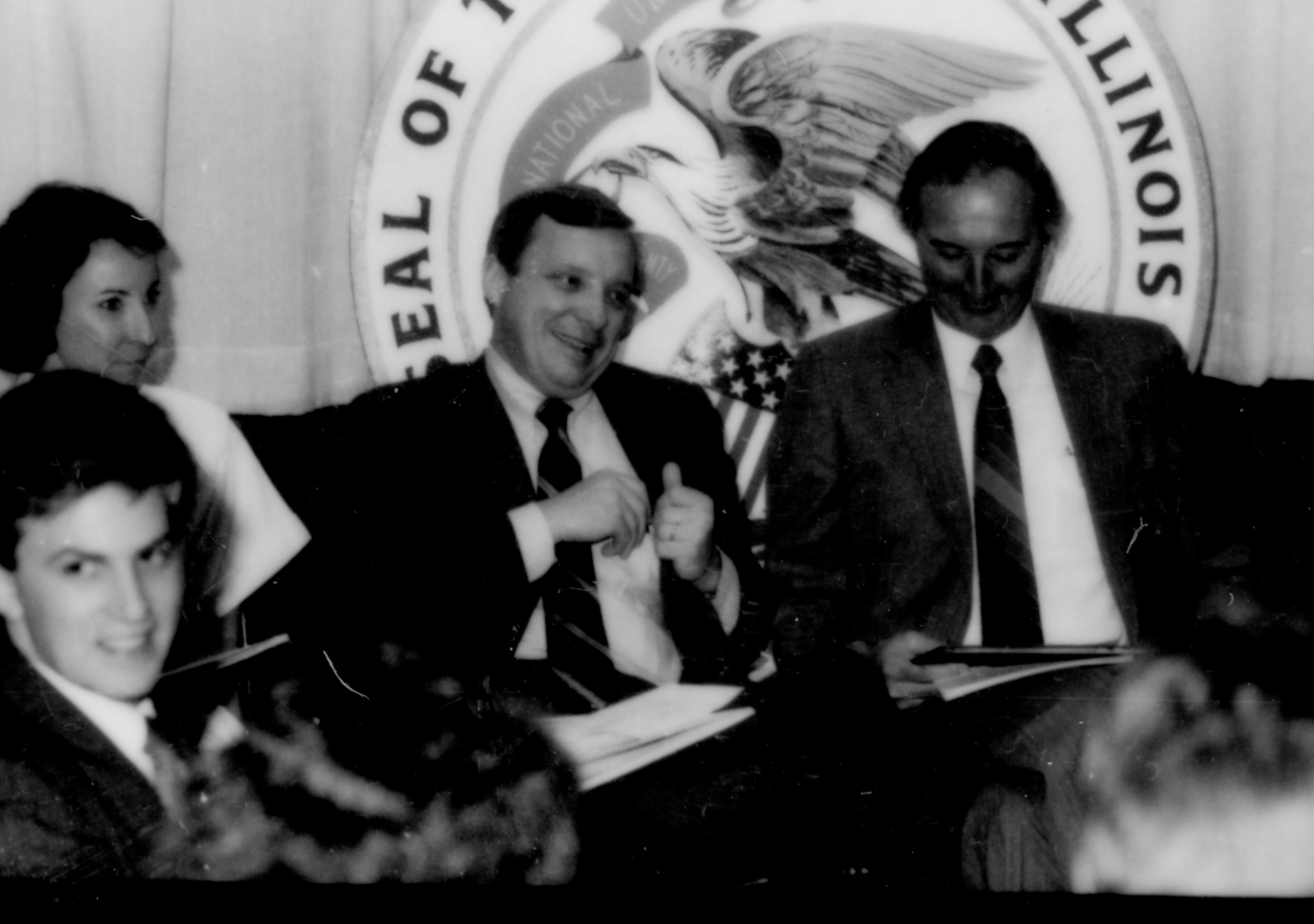 Four people sitting in front of state seal. Lincoln Home NHS- Paul Findley and Michel VIP visit, 125 Finley, Michel, visit, program