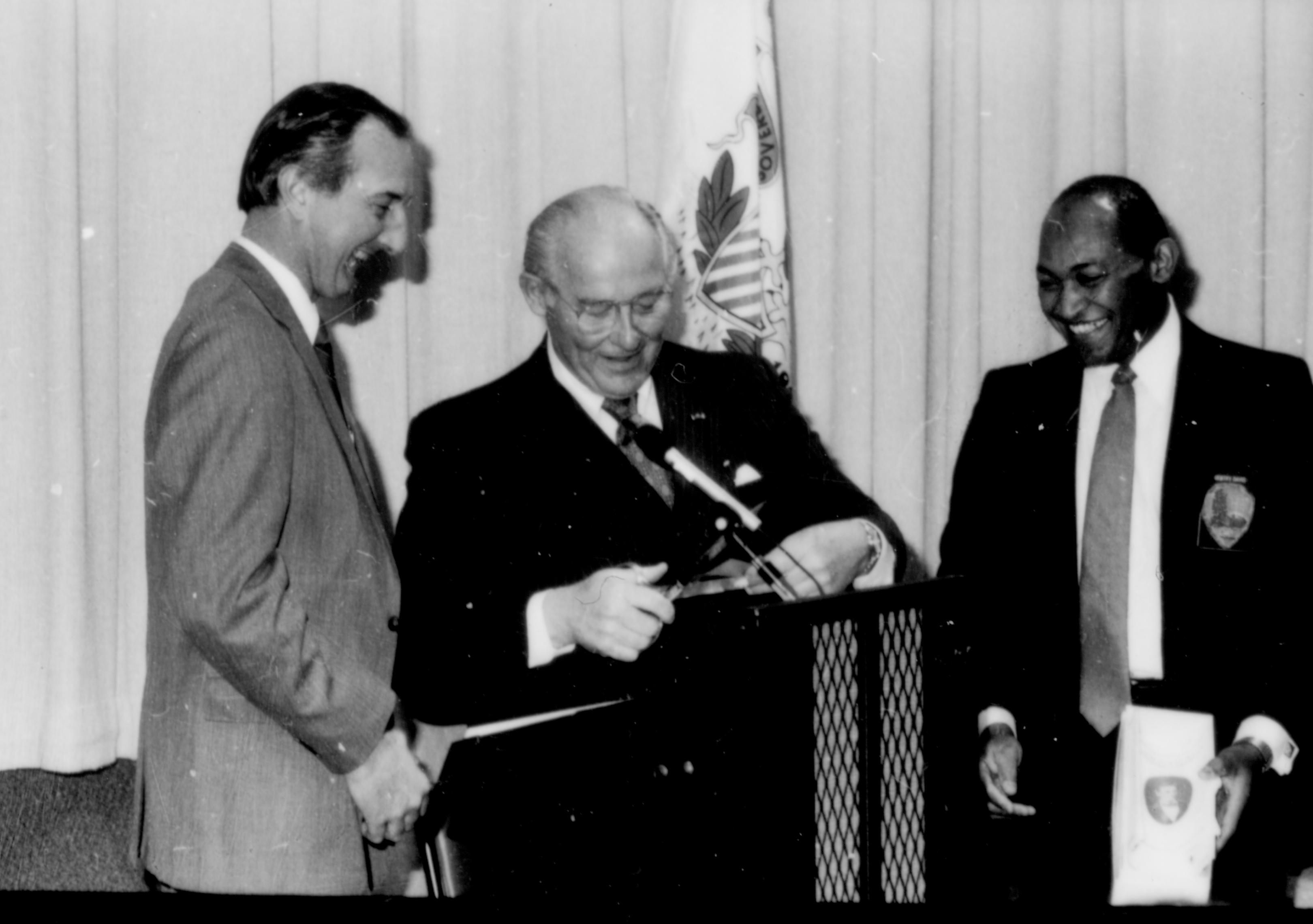 Three men standing at speakers podium. Lincoln Home NHS- Paul Findley and Michel VIP visit, 125 Finley, Michel, visit, program