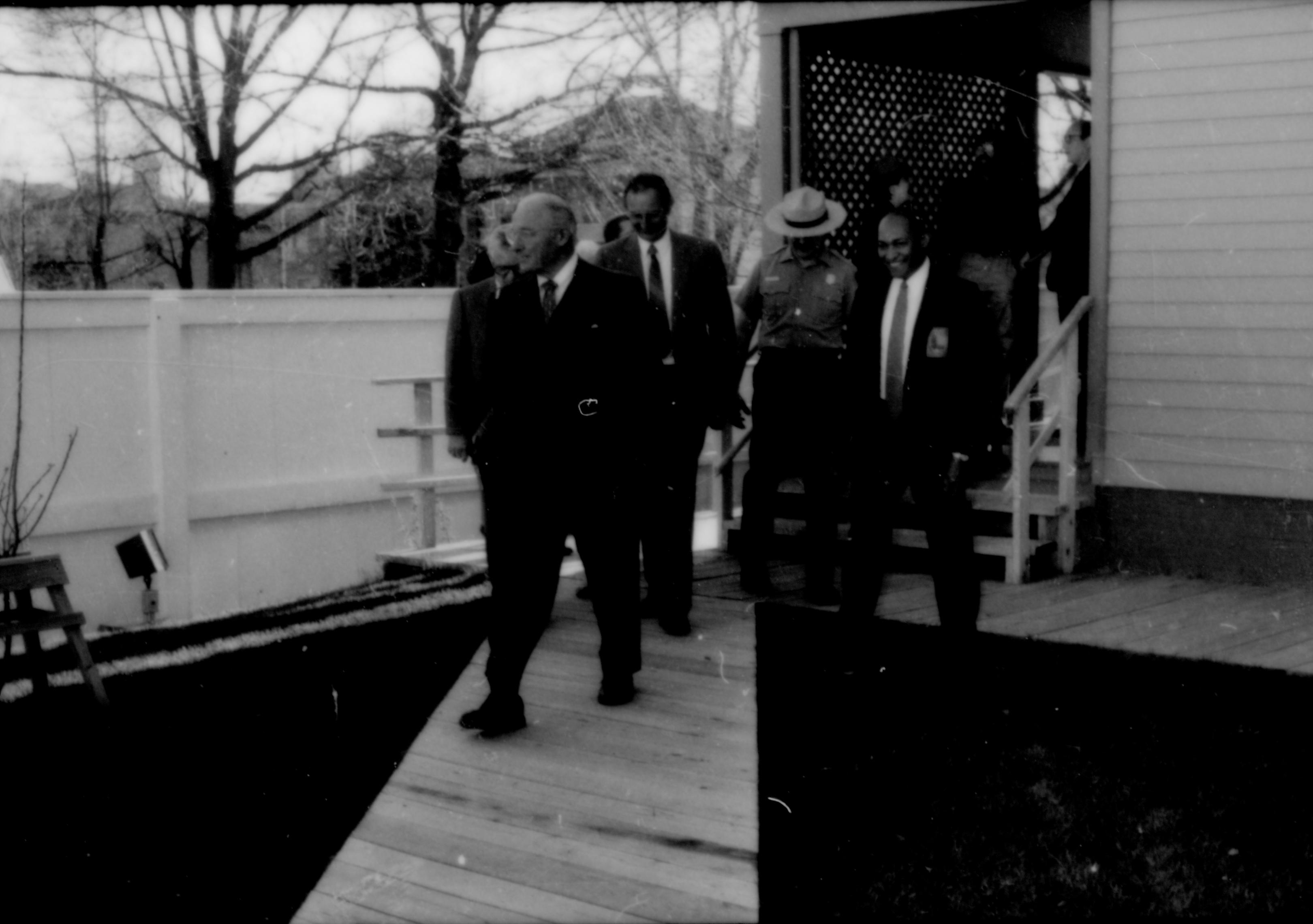 Men walking down board walk behind home. Lincoln Home NHS- Paul Findley and Michel VIP visit, 127 Finley, Michel, visit, tour