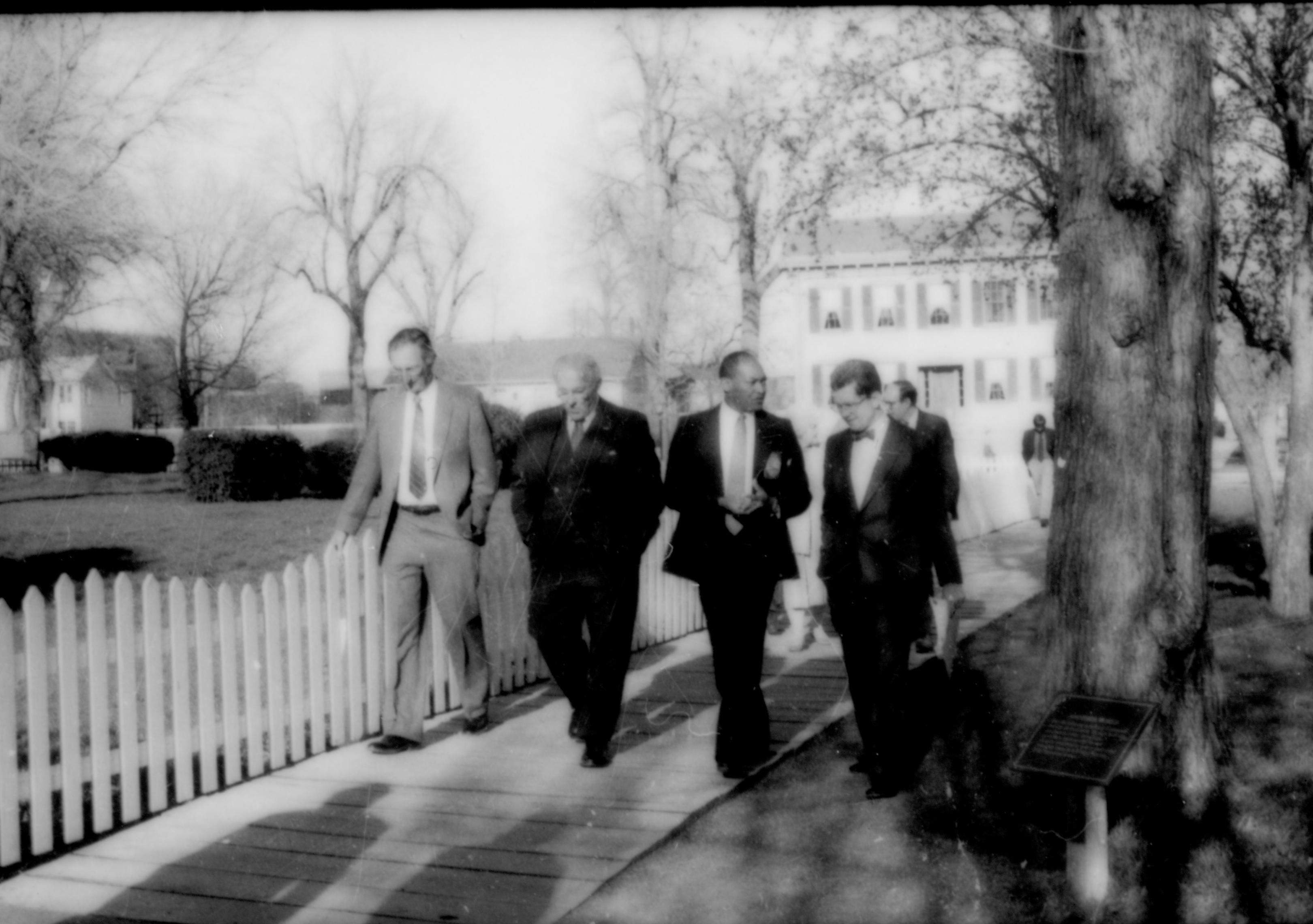 Group of men walking on brick walk by Burch lot. Lincoln Home NHS- Paul Findley and Michel VIP visit, 128 Finley, Michel, visit, tour