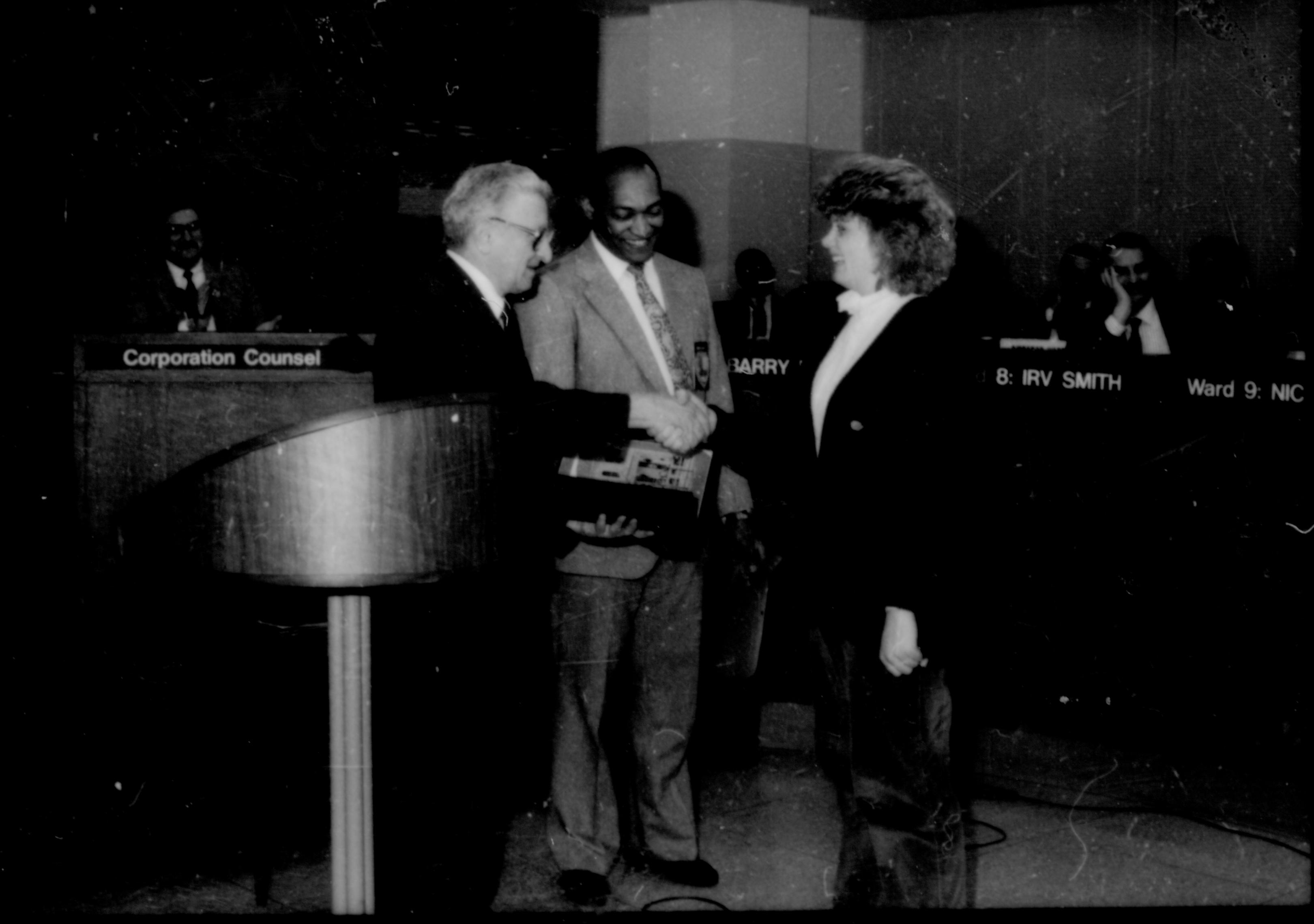 Two men giving award to a lady. Lincoln Home NHS- City Council Ollie Christmas Award, 133 Award, program