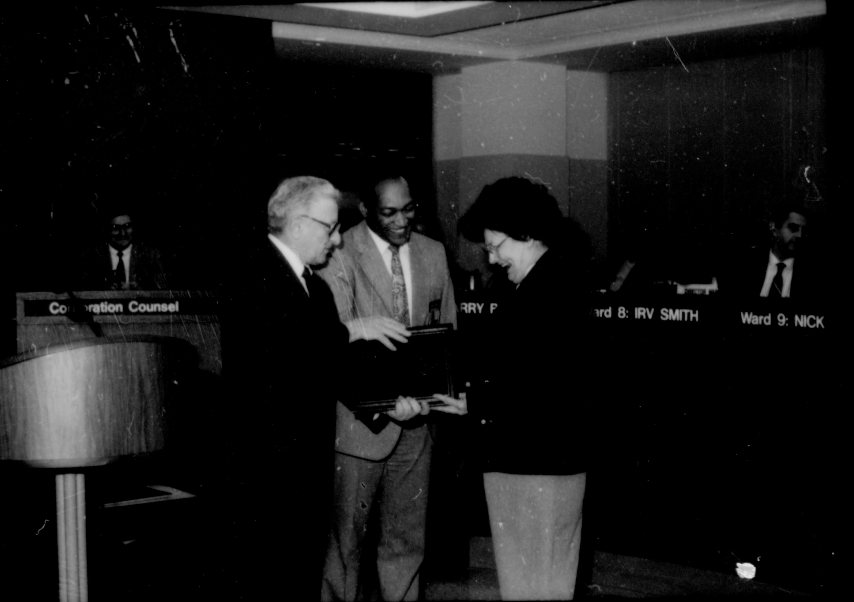 Two men giving award to a lady. Lincoln Home NHS- City Council Ollie Christmas Award, 133 Award, program