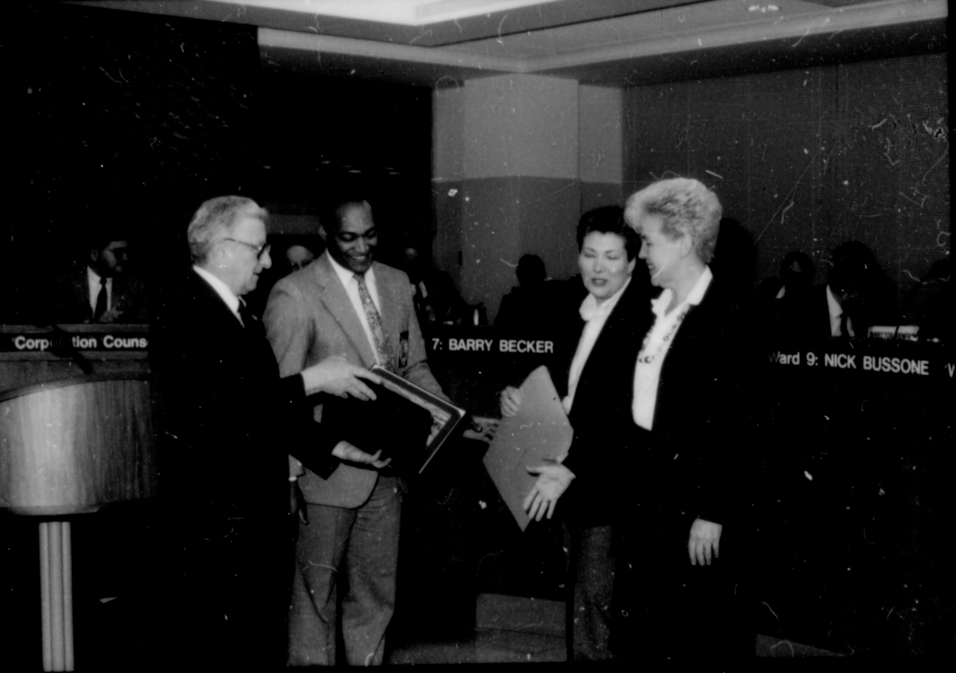 Two men giving award to two ladies. Lincoln Home NHS- City Council Ollie Christmas Award, 133 Award, program