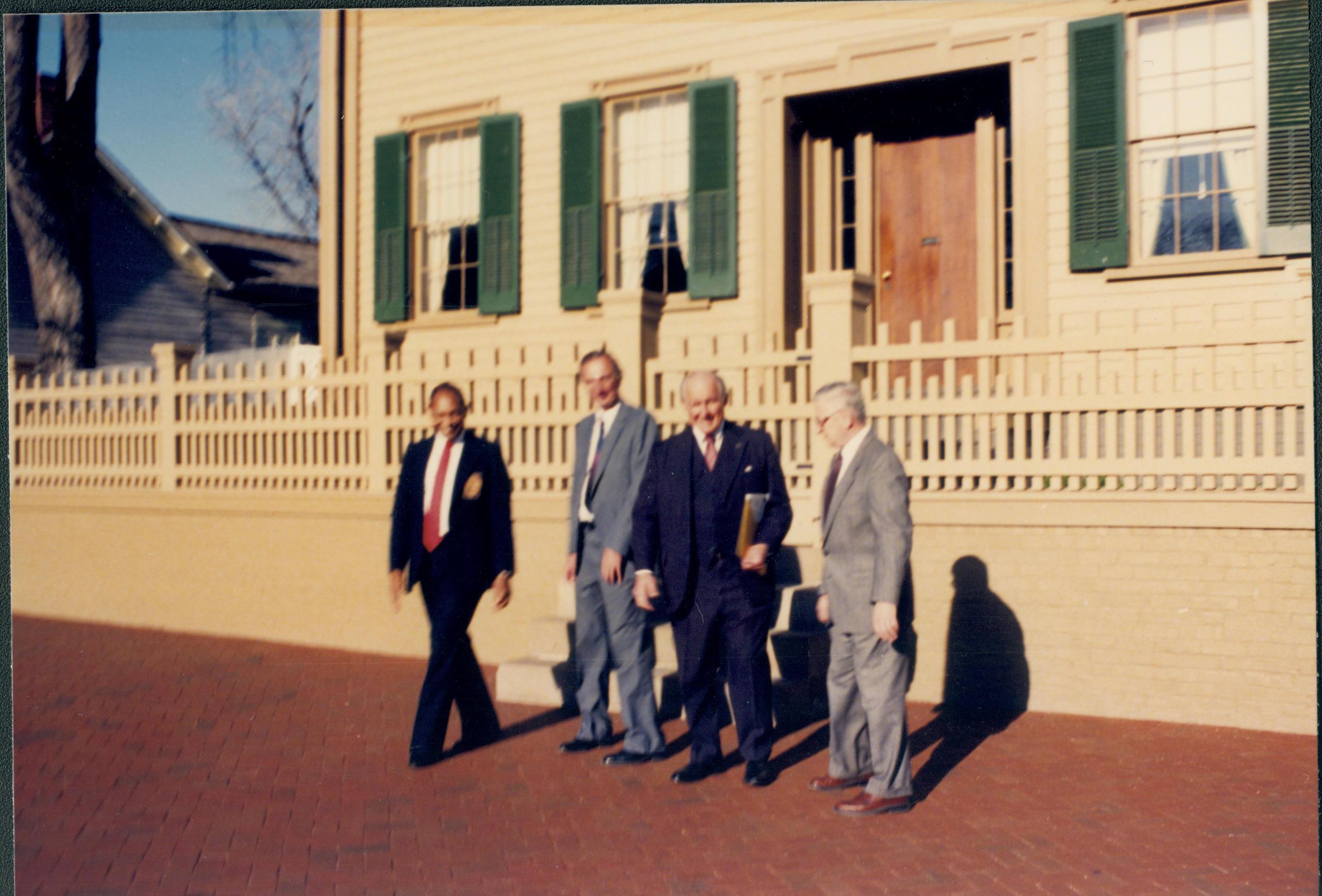 Four men standing in front of Lincoln home. Lincoln Home NHS- City Council Ollie Christmas Award Michel, tour, visit