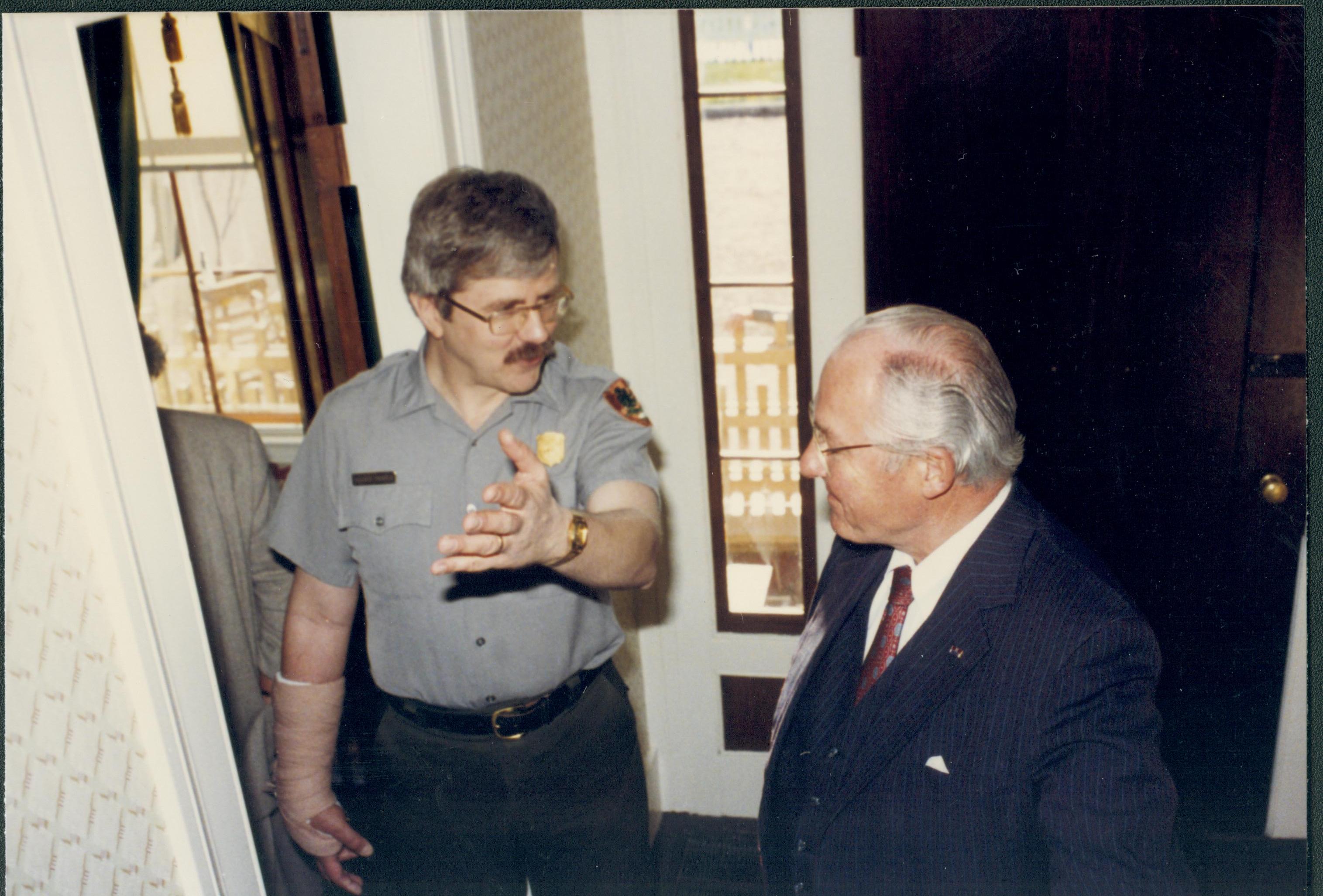 Two men by front door of Lincoln home. Lincoln Home NHS- City Council Ollie Christmas Award Michel, tour, visit