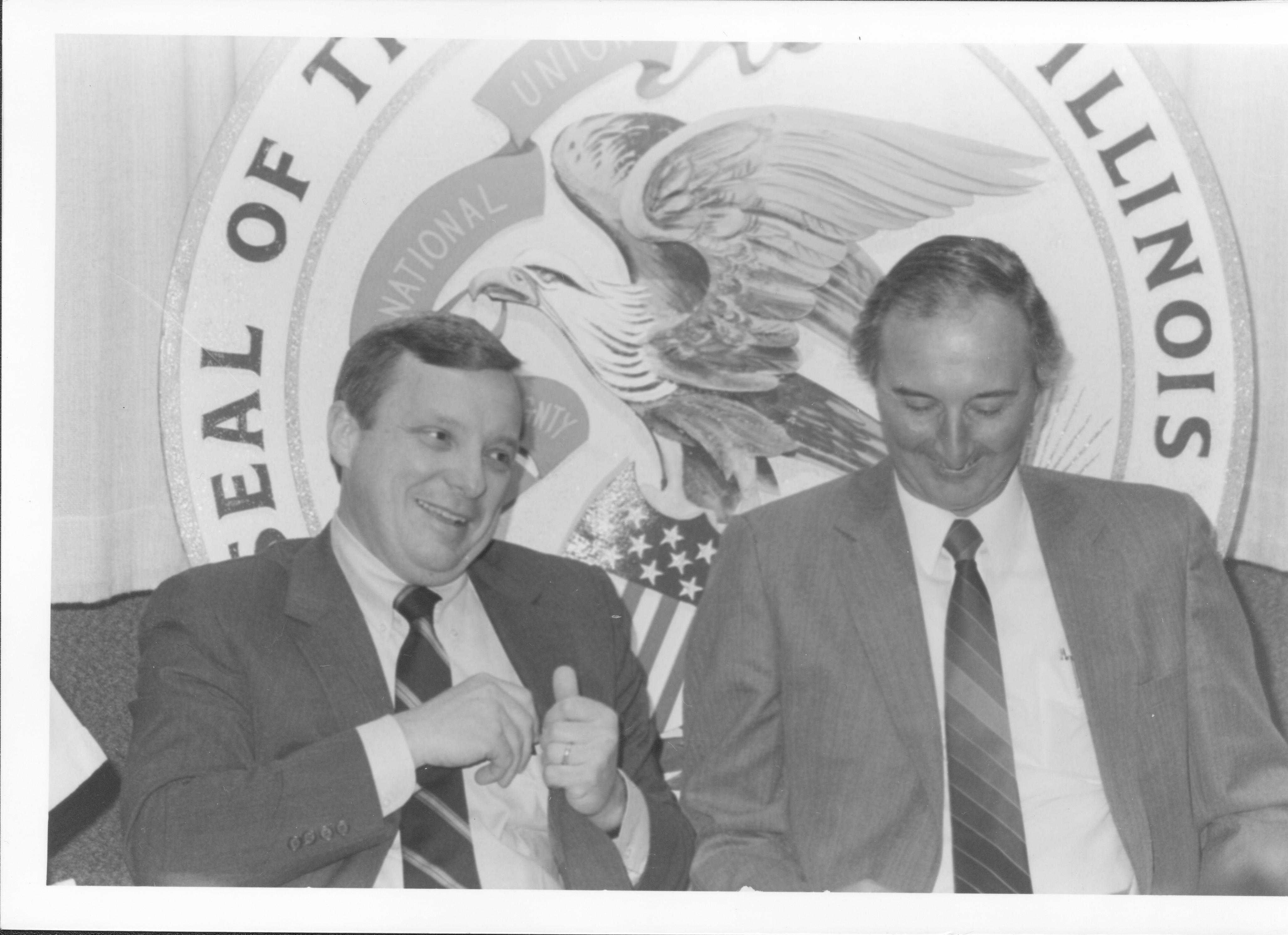 Two men in front of state seal. Lincoln Home NHS- VIP Findley and Michels Visit tour, visit