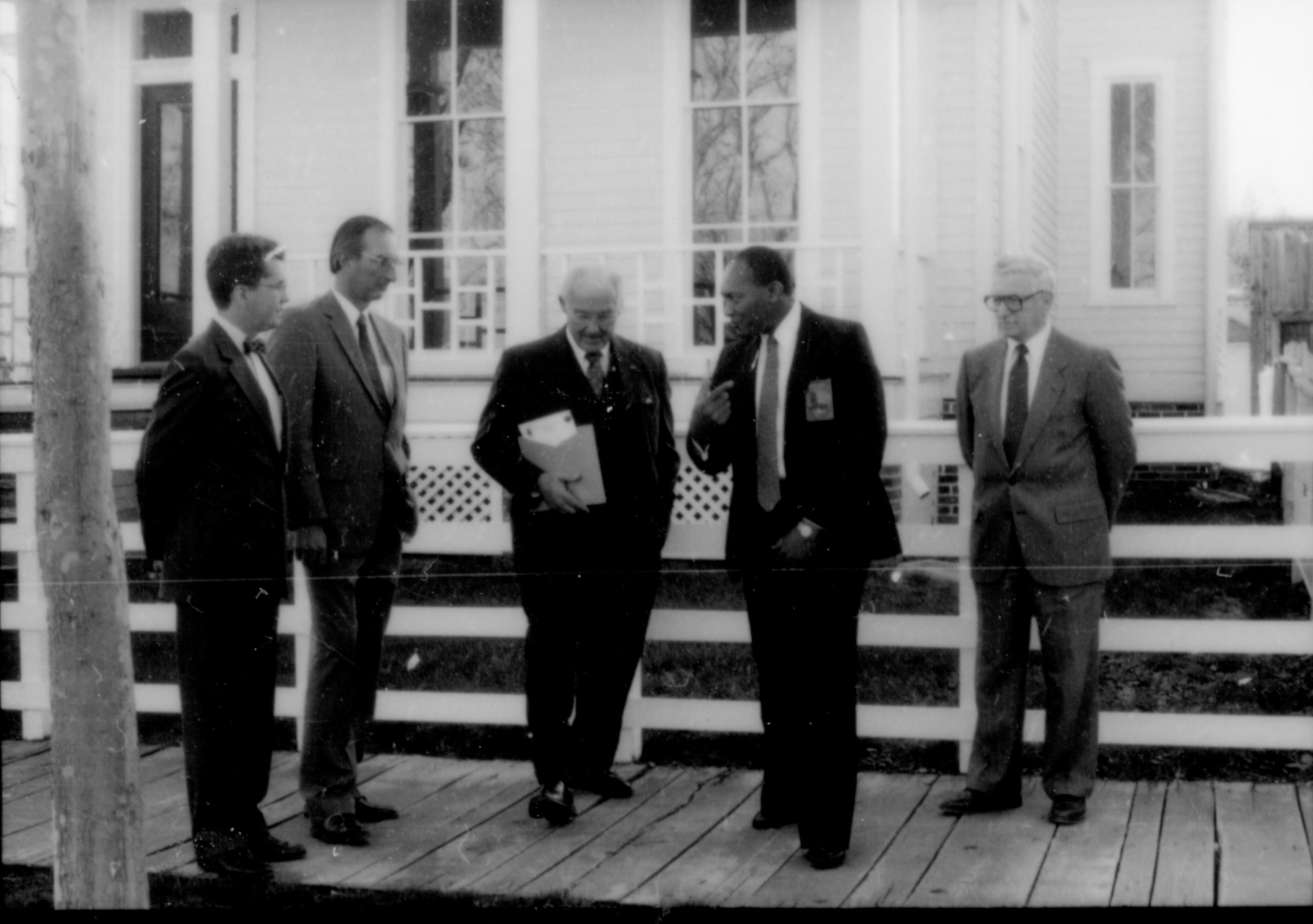 Men standing on board walk in front of white fence. Lincoln Home NHS- Paul Findley and Michel VIP visit, 116 Finley, Michel, tour, visit