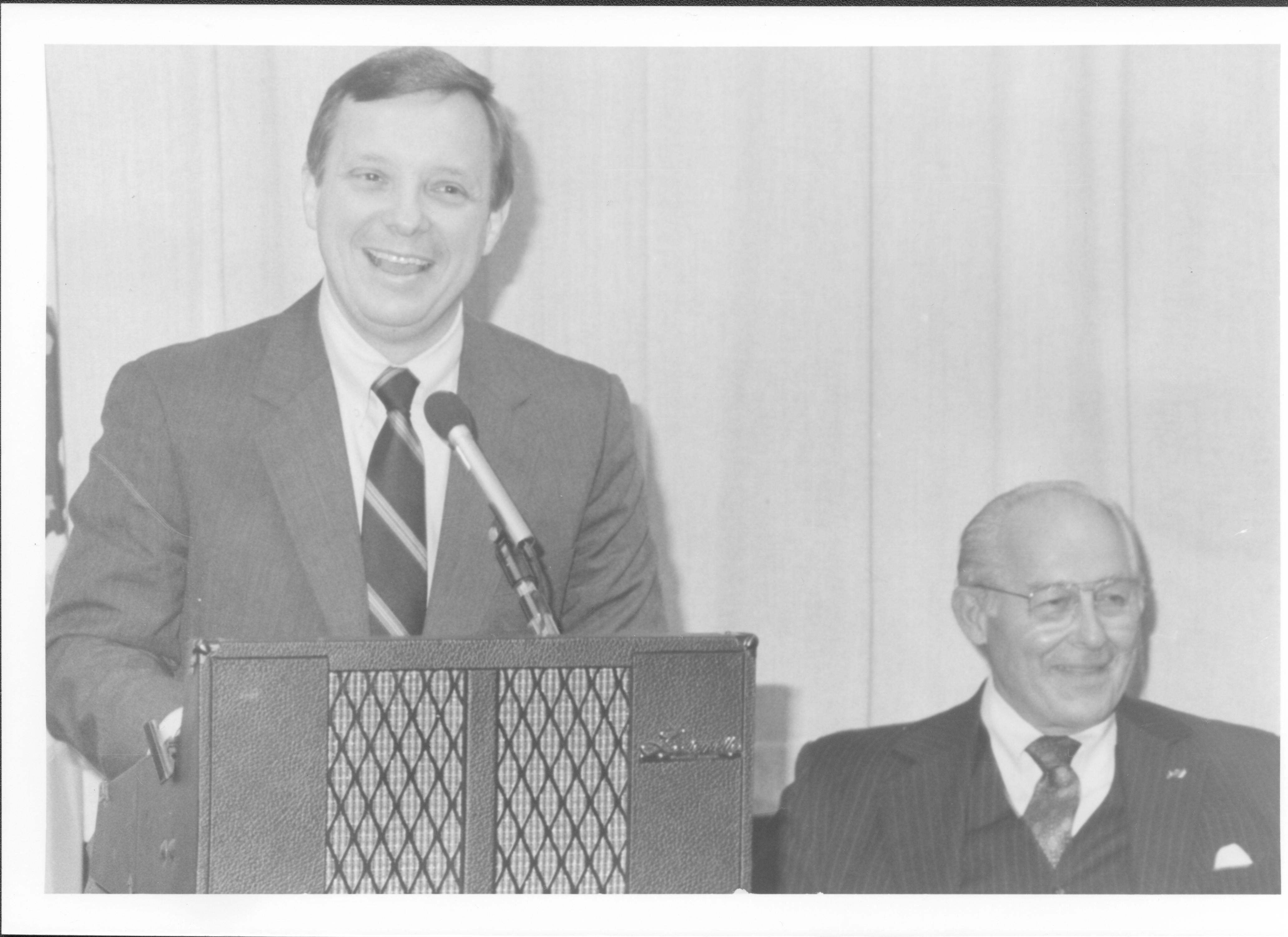 Man at podium, another seated at his left. Lincoln Home NHS- VIP Findley and Michels Visit tour, visit