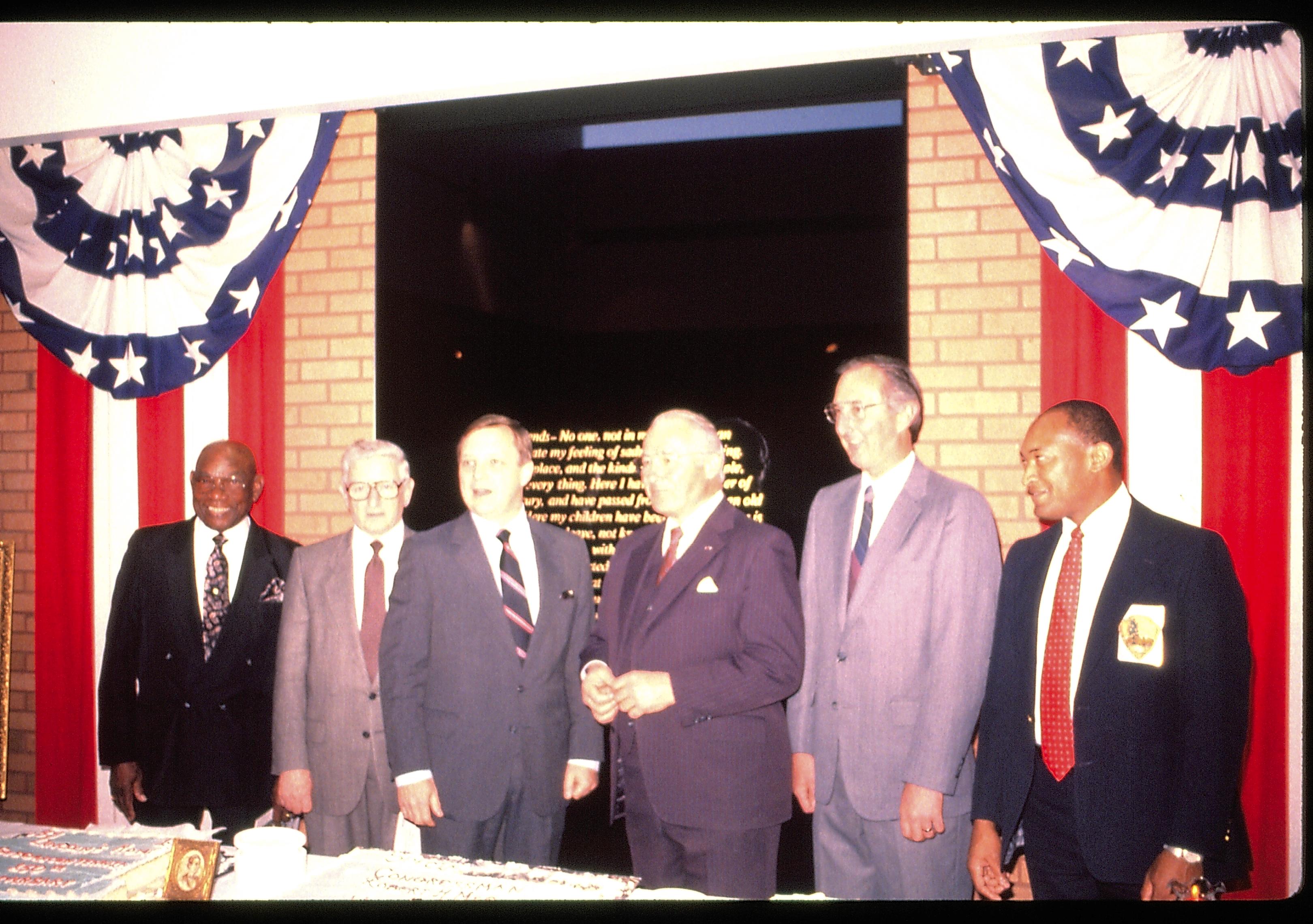 Six men standing behind table for photograph. Lincoln Home NHS- VIP Findley and Michels Visit award, visit, ceremony