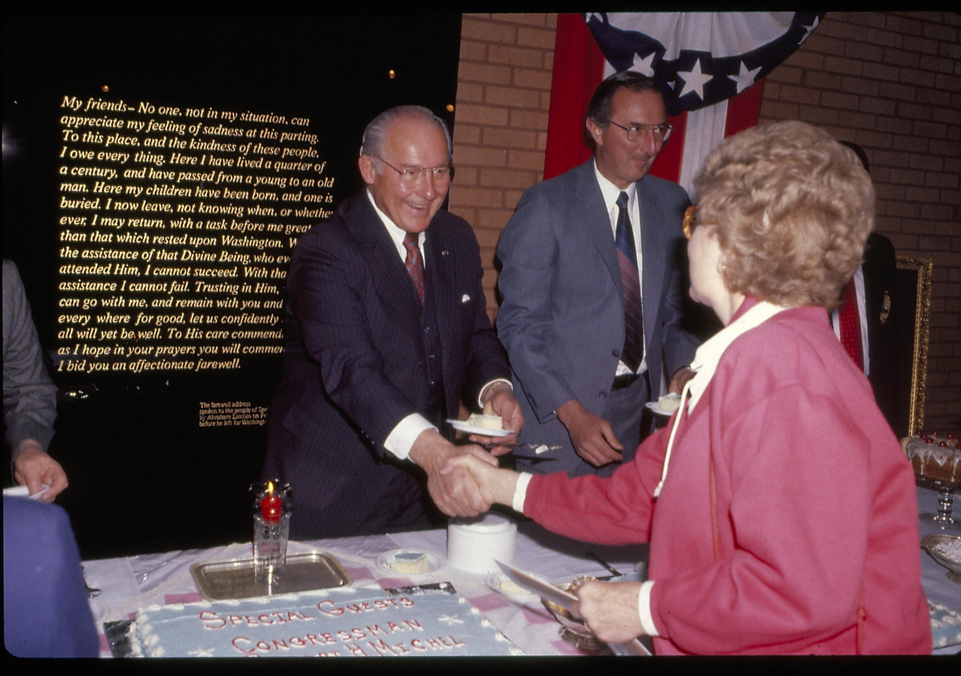 Man shaking hands with lady at refreshment table Lincoln Home NHS- VIP Findley and Michels Visit award, visit, reception