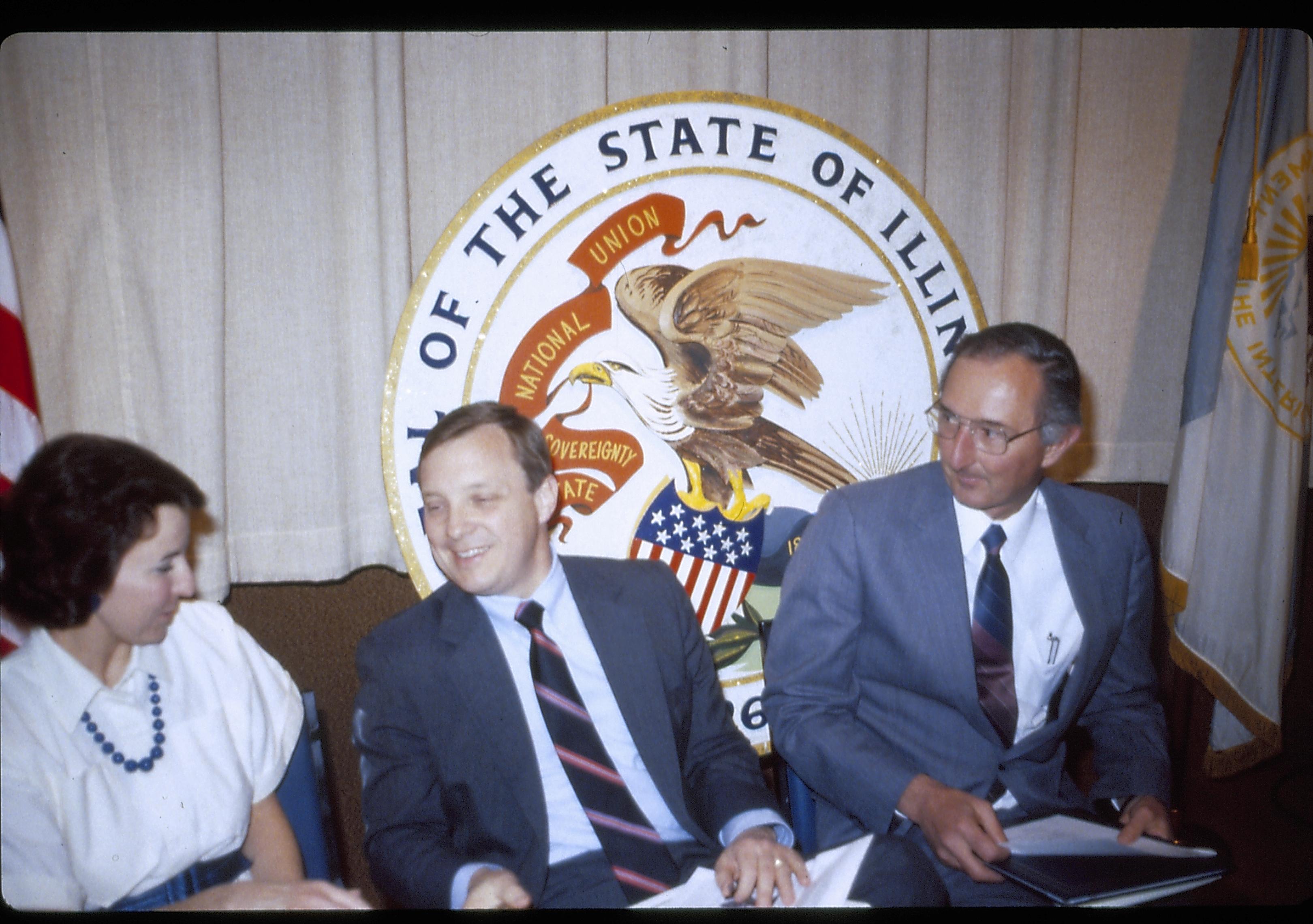 Three people seated in front of state seal. Lincoln Home NHS- VIP Findley and Michel Visit award, visit