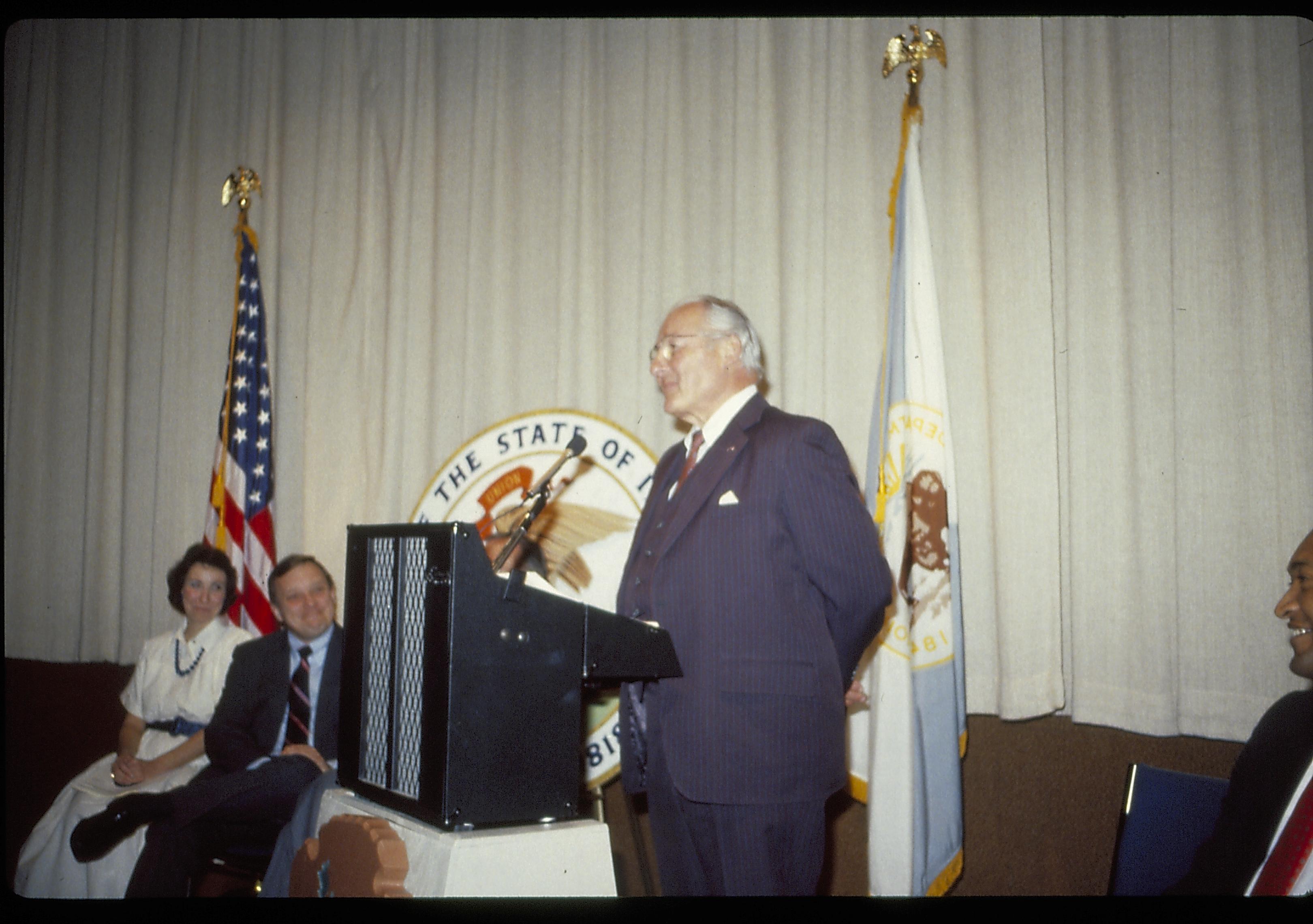 Man speaking at podium in VC theater. Lincoln Home NHS- VIP Findley and Michel Visit award, visit, reception