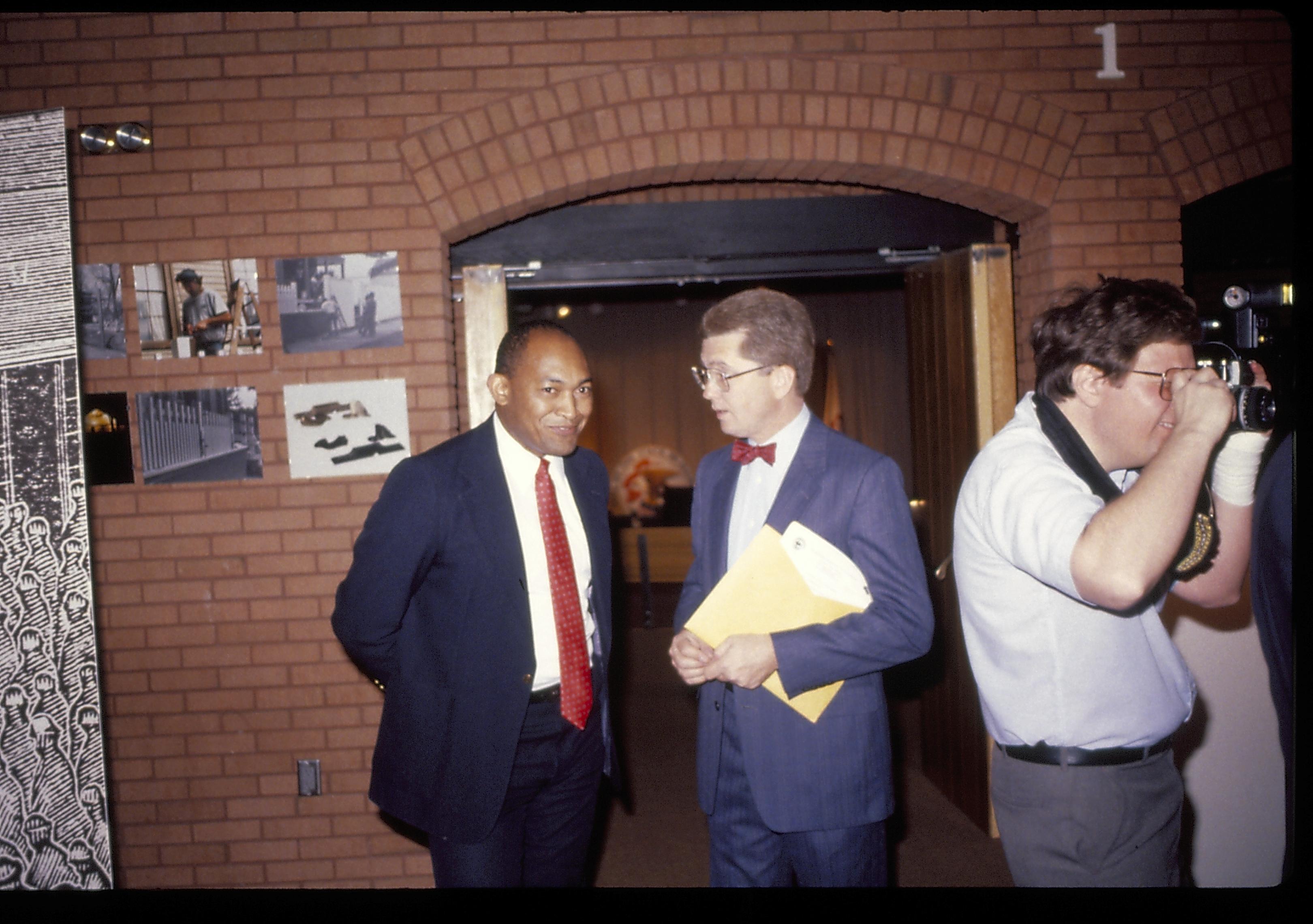 Two men talking outside VC theater enterance. Lincoln Home NHS- VIP Findley and Michel Visit award, visit, reception