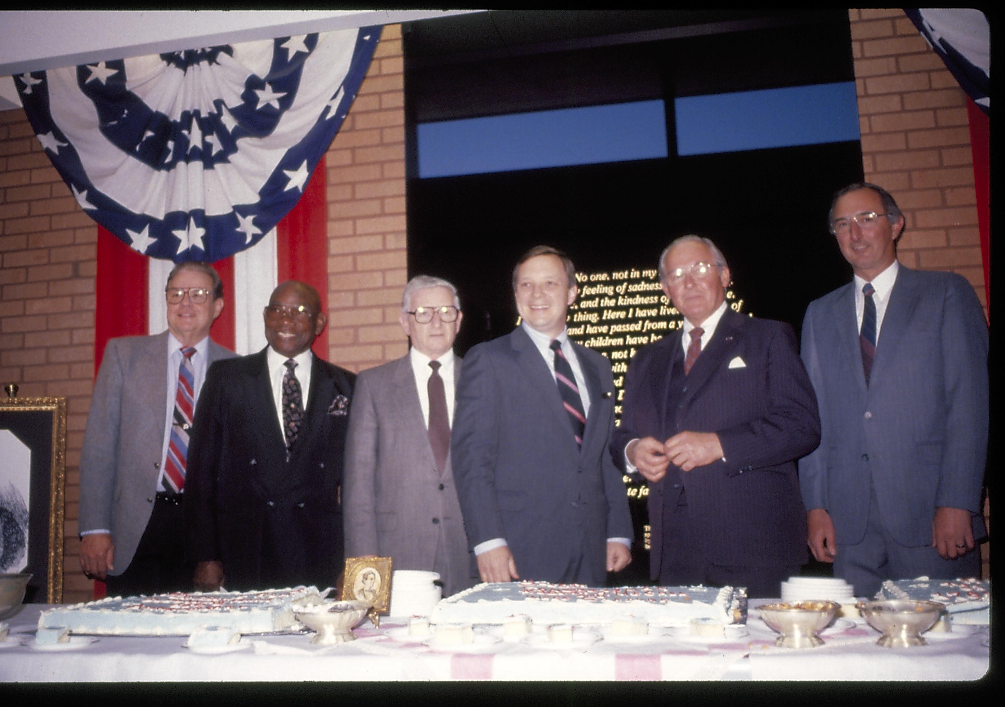 Six men standing behind cake table. Lincoln Home NHS- VIP Findley and Michel Visit award, visit, reception