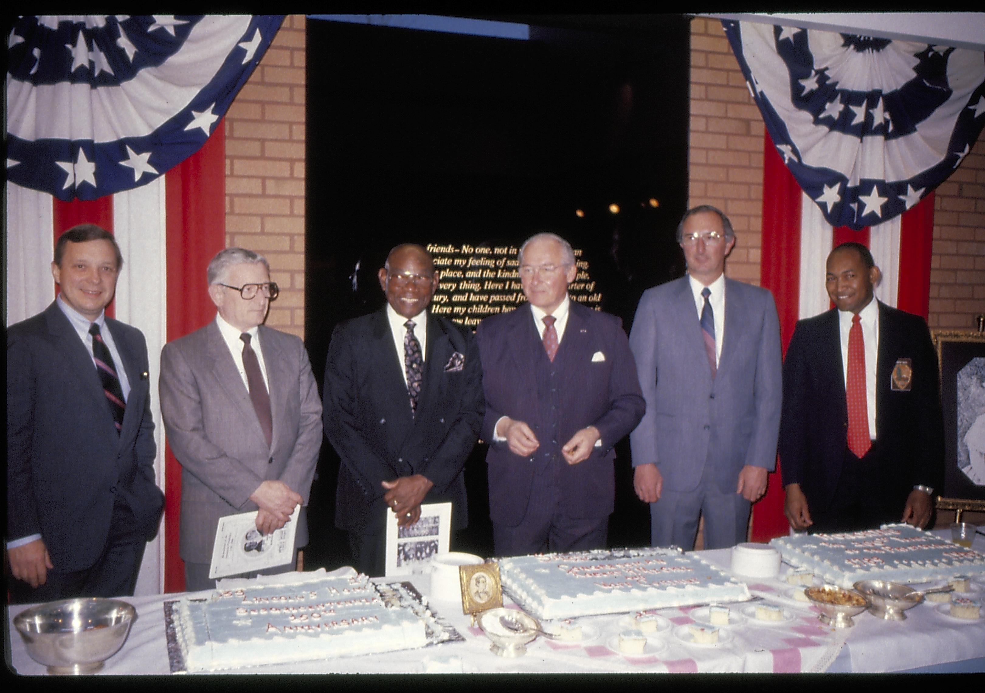 Six men standing behind cake table. Lincoln Home NHS- VIP Findley and Michel Visit award, visit, reception