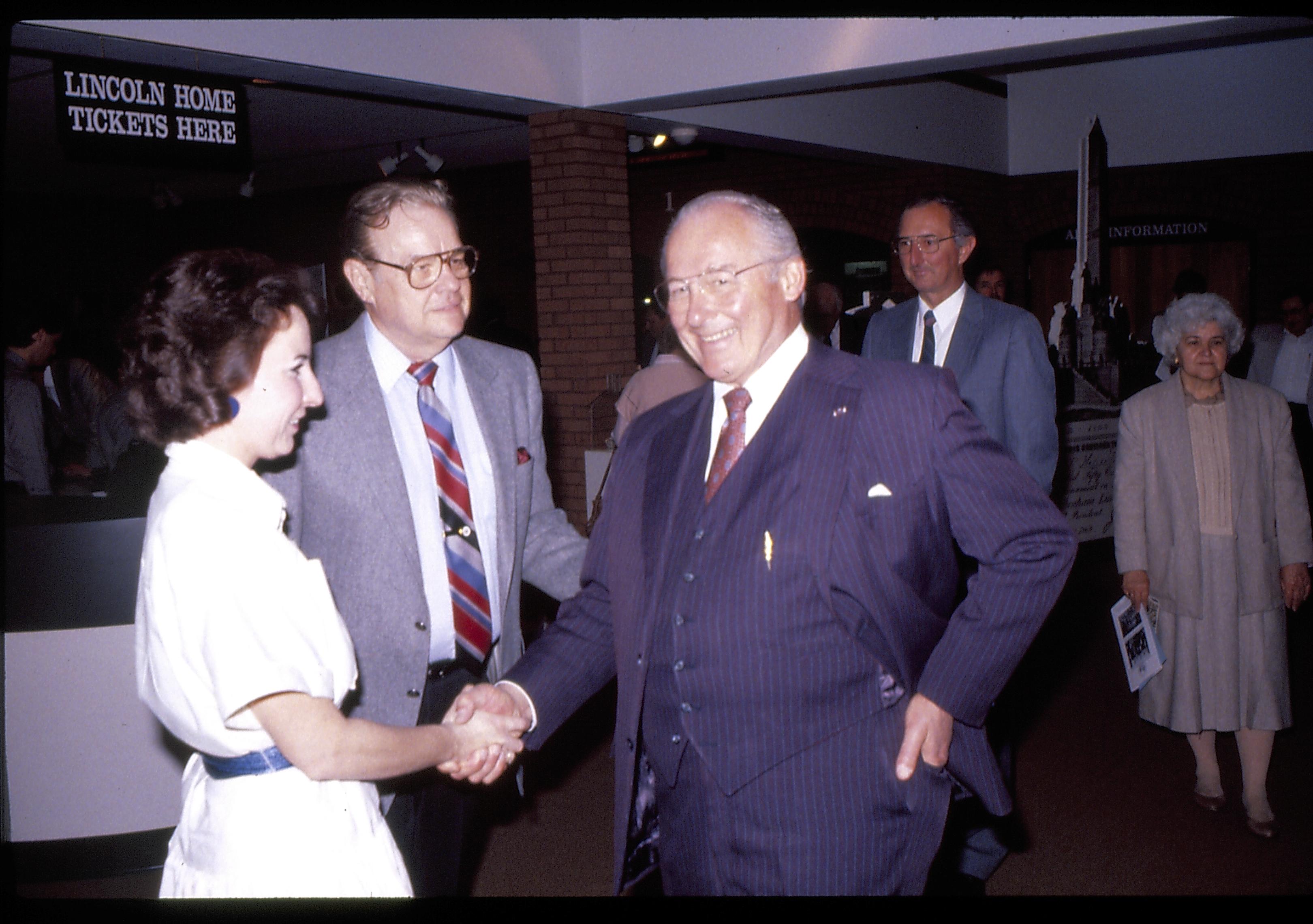 Man and woman shaking hands in VC. Lincoln Home NHS- VIP Findley and Michel Visit award, visit, reception