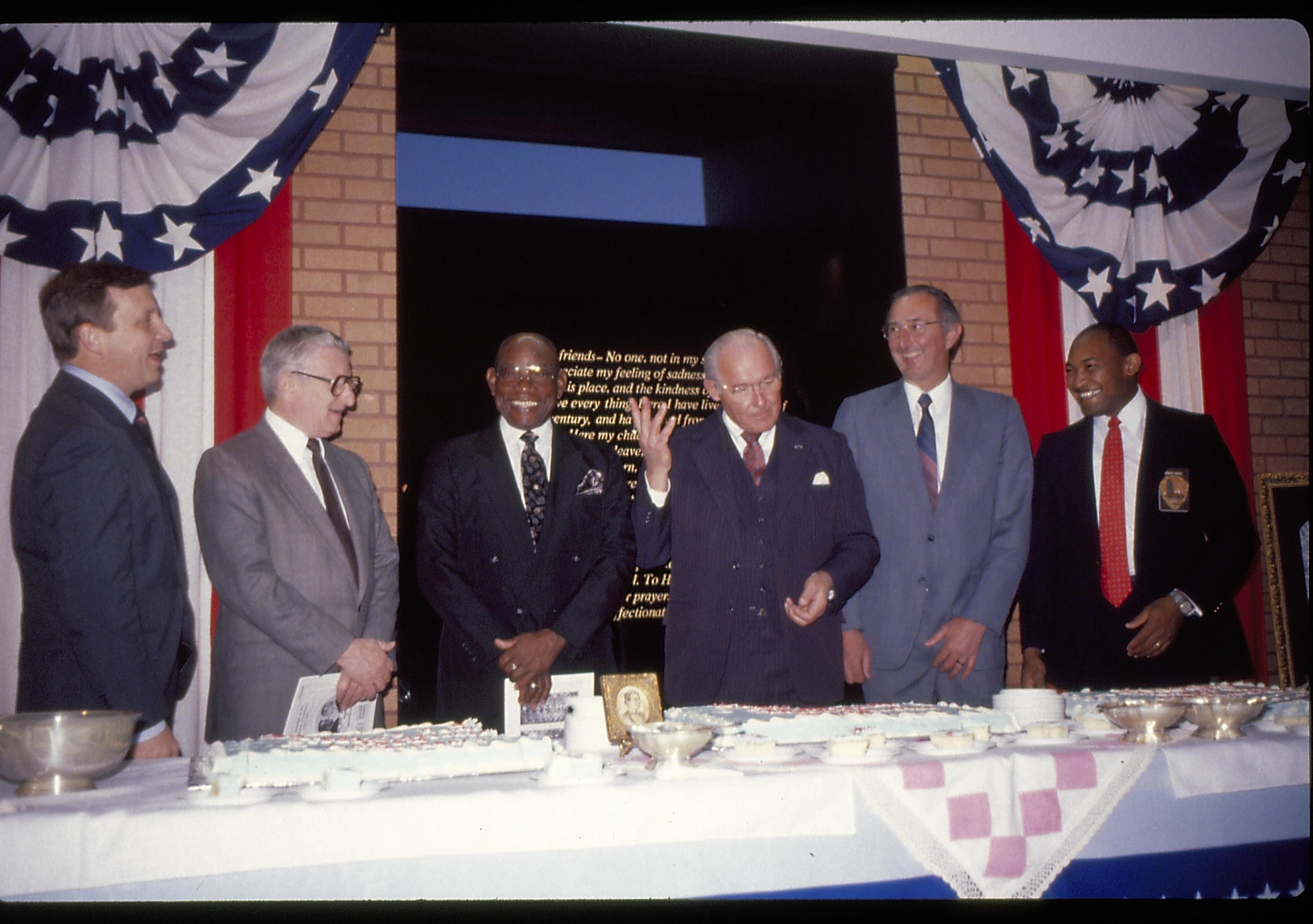 Six men standing behind cake table. Lincoln Home NHS- VIP Findley and Michel Visit award, visit, reception