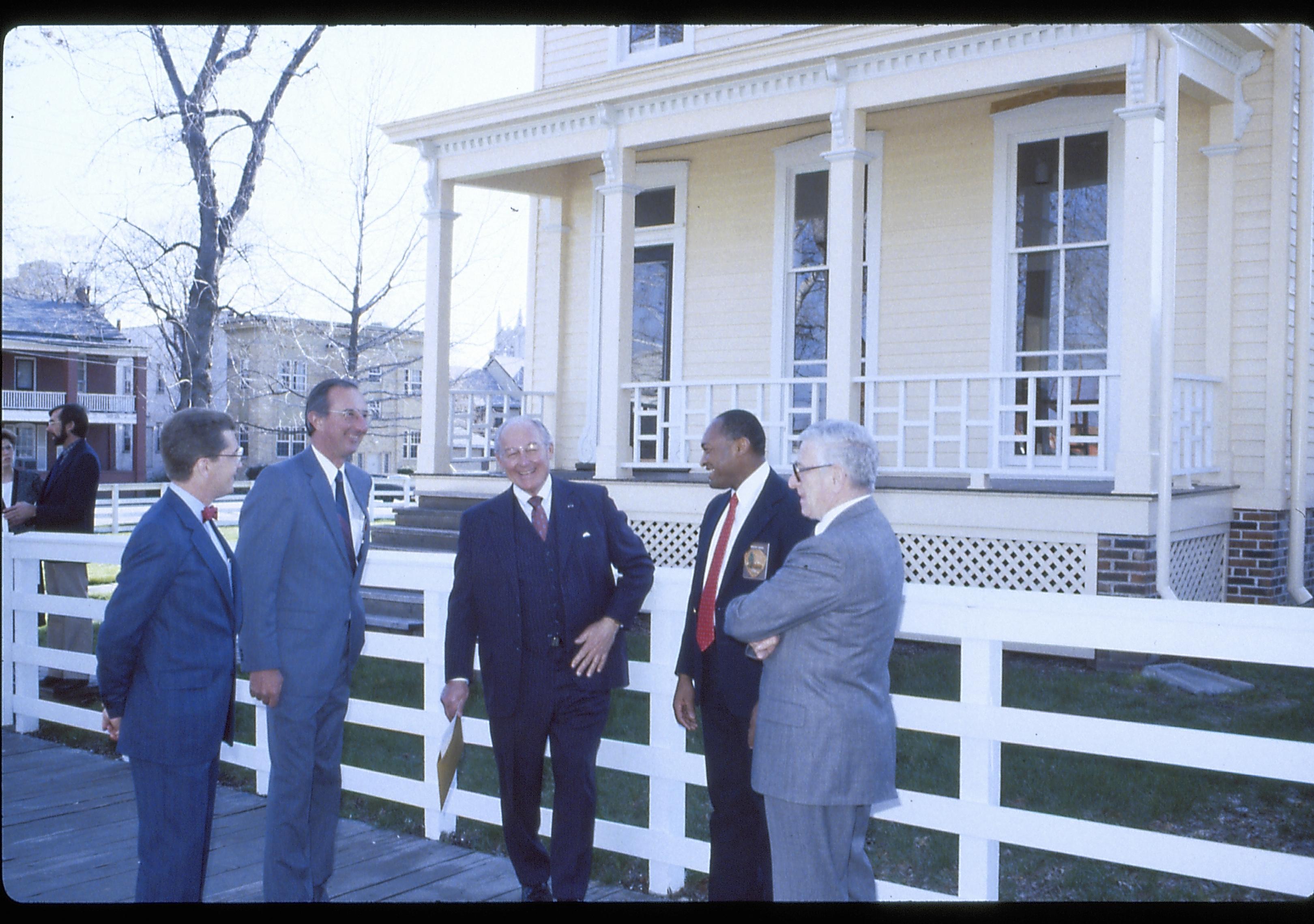 Five men standing on board walk by a white fence. Lincoln Home NHS- VIP Findley and Michel Visit award, visit, tour