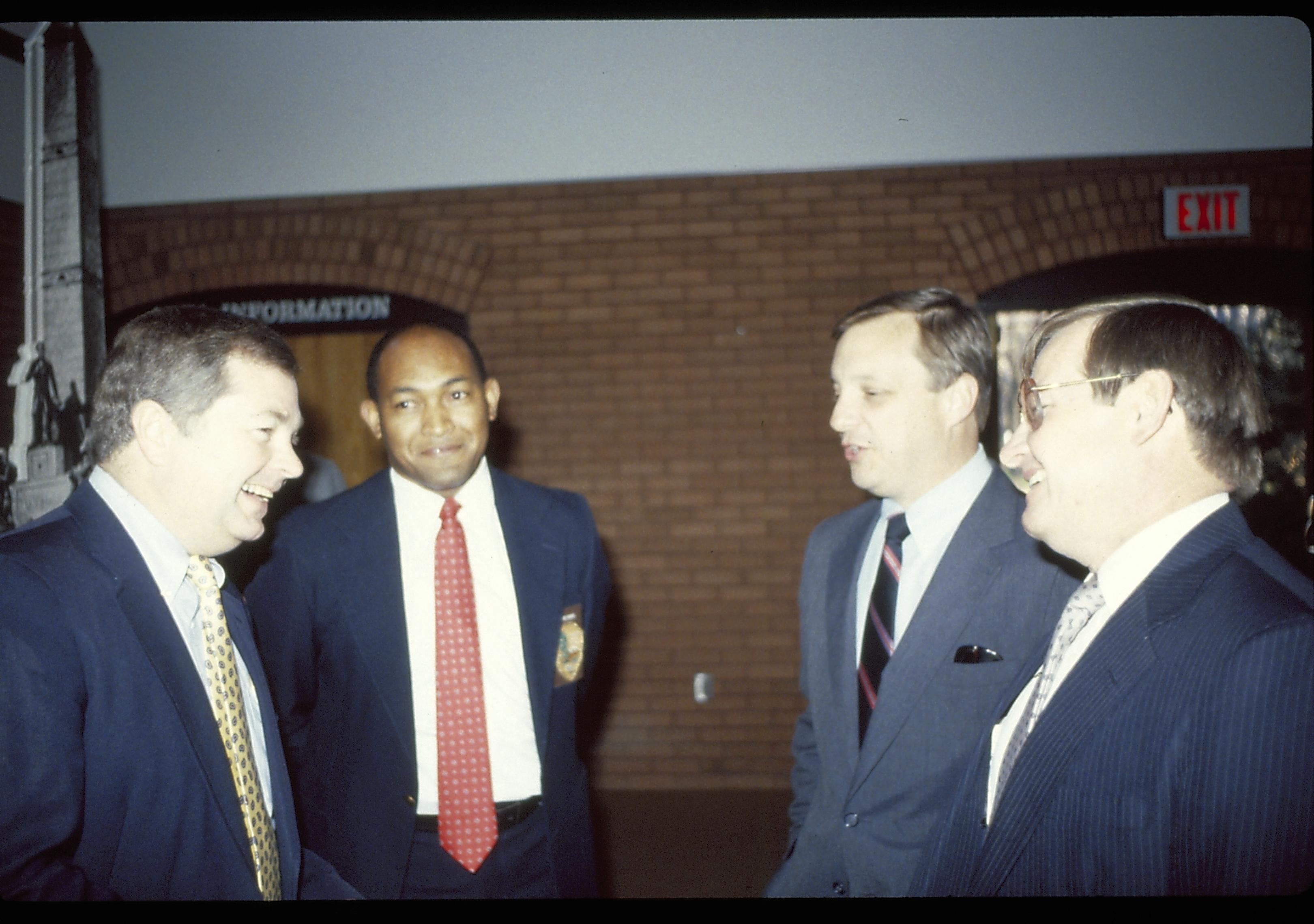 Four men conversing in VC. Lincoln Home NHS- VIP Findley and Michel Visit award, visit