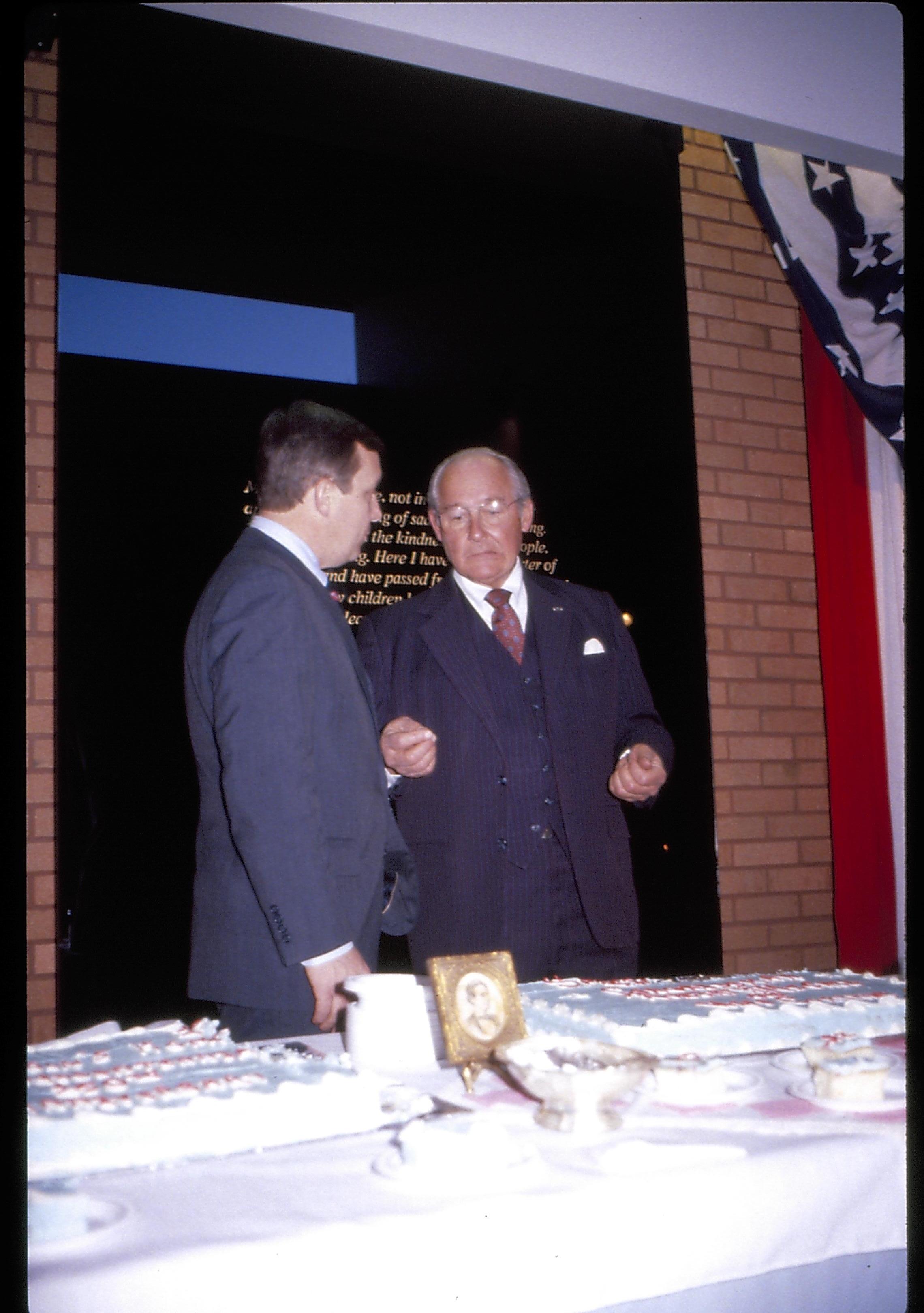 Two men talking standing in front of farewell address sign. Lincoln Home NHS- VIP Findley and Michel Visit award, visit, reception