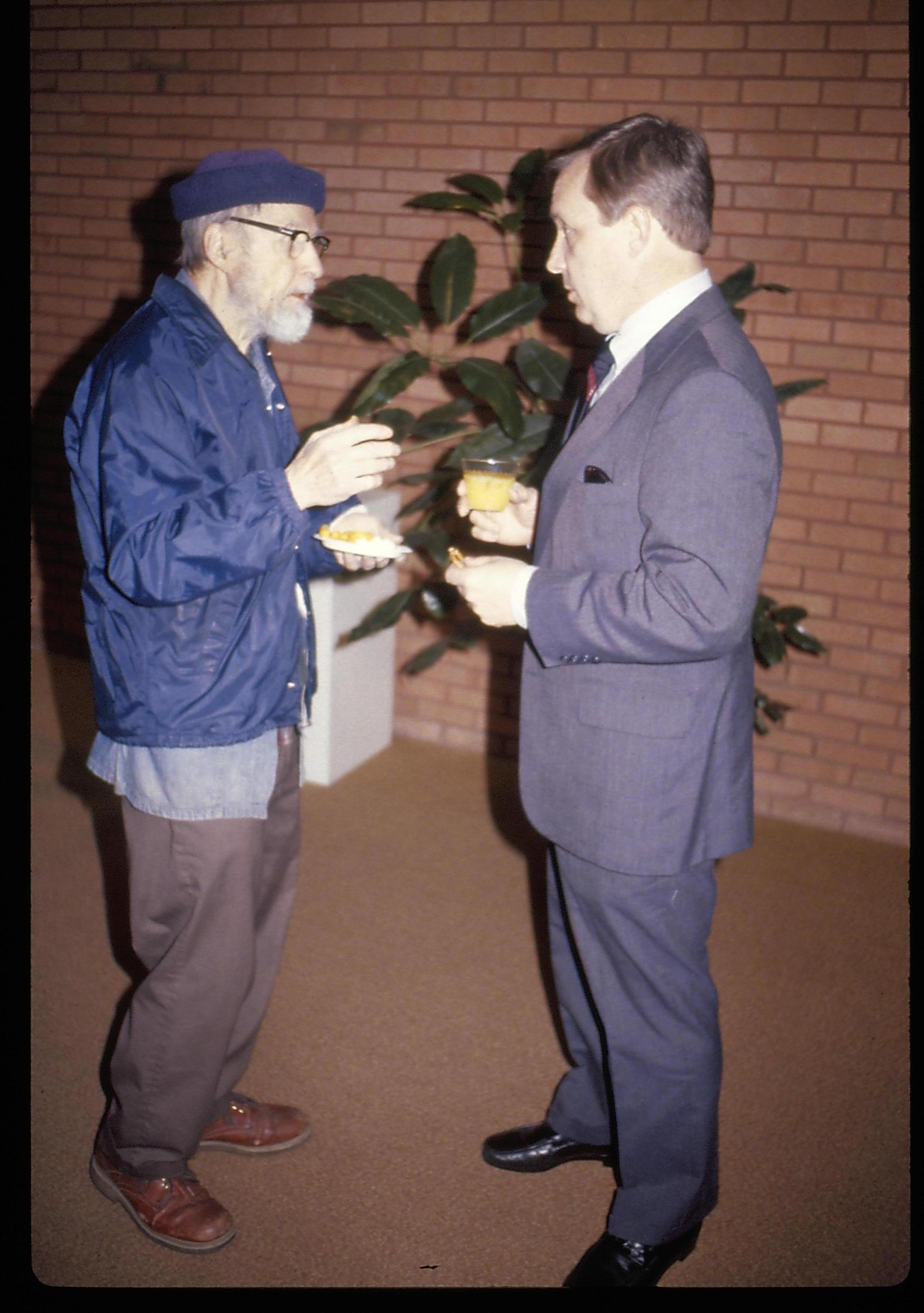 Two men standing, eating, conversing in VC. Lincoln Home NHS- VIP Findley and Michel Visit award, visit, reception