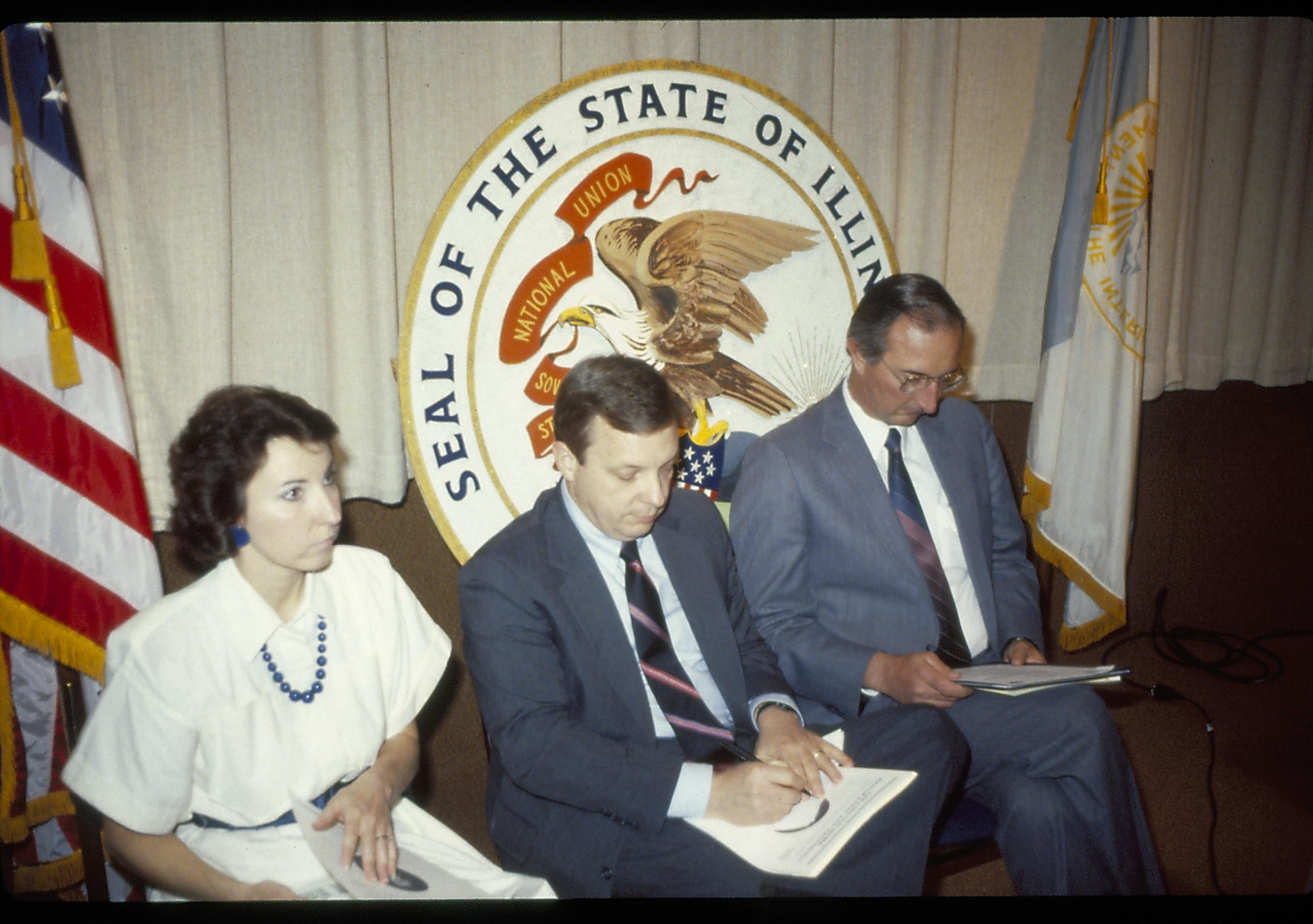 Three people seated in front of state seal. Lincoln Home NHS- VIP Findley and Michel Visit award, visit, reception