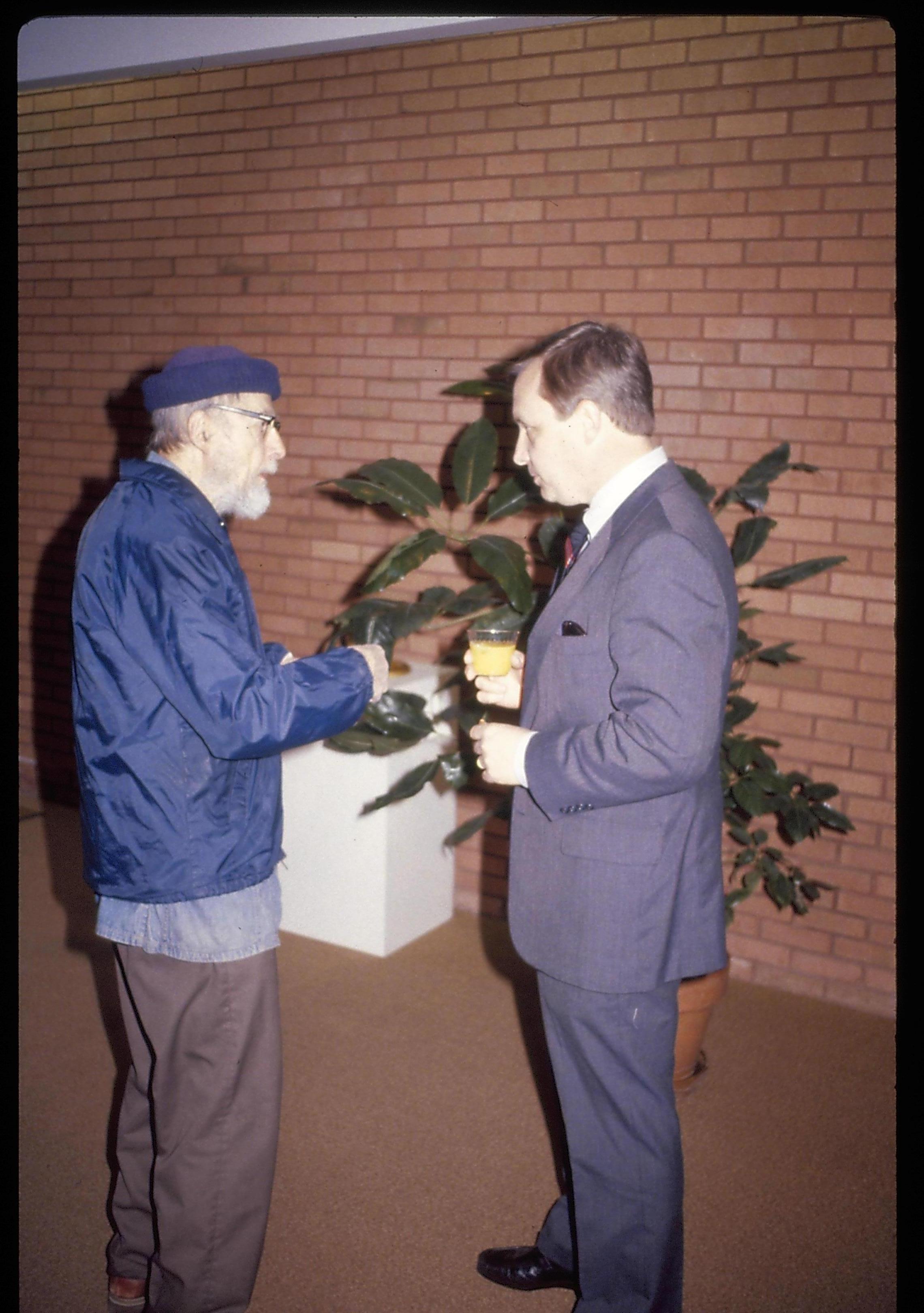 Two men standing, eating, conversing in VC. Lincoln Home NHS- VIP Findley and Michel Visit award, visit, reception