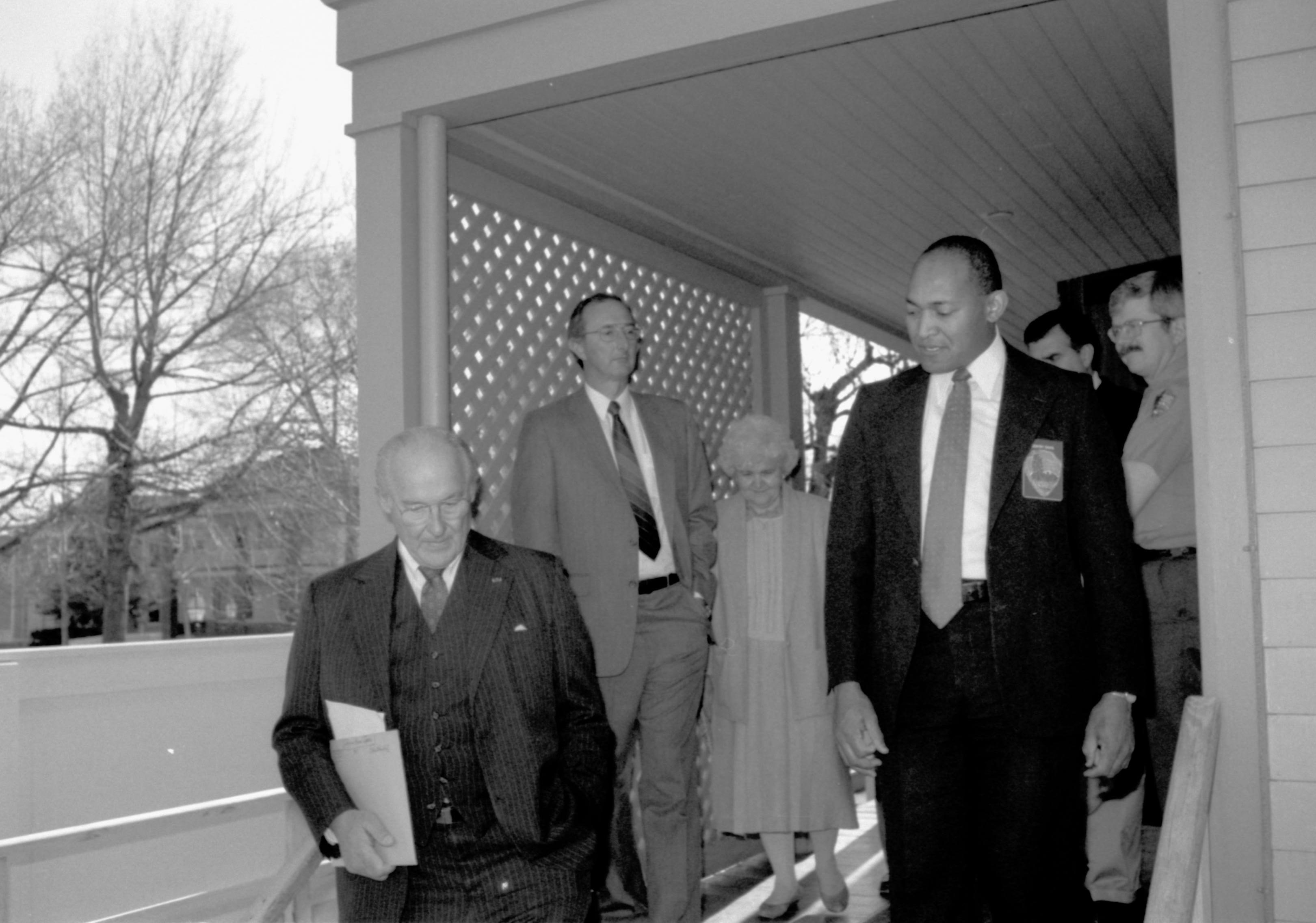 Men descending stairs on side porch of Home. Lincoln Home NHS- VIP Findley and Michel Visit, 65A award, visit, tour