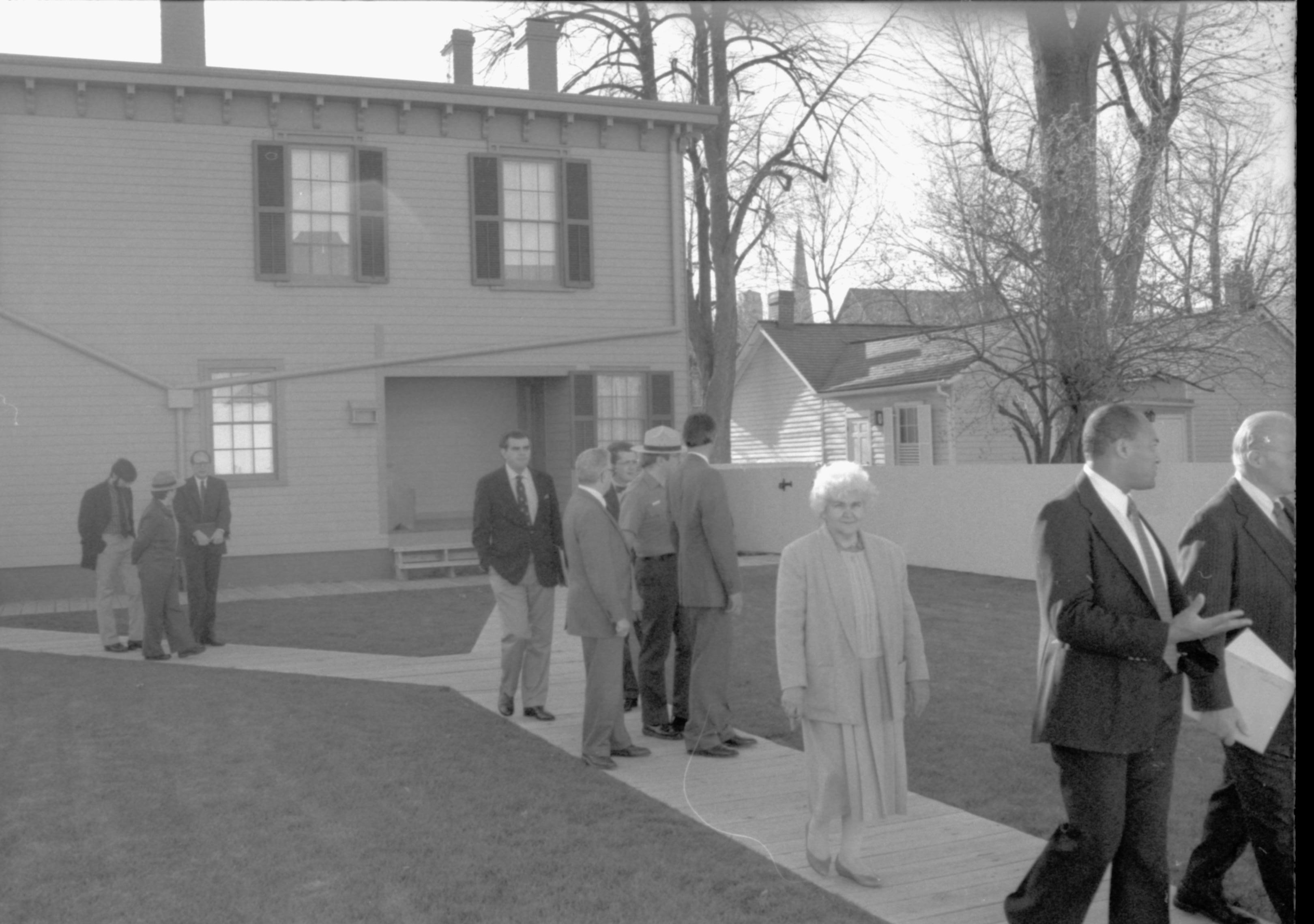 Group walking down boardwalk behind Home.                 Lincoln Home NHS- VIP Findley and Michel Visit, 65A award, visit, tour