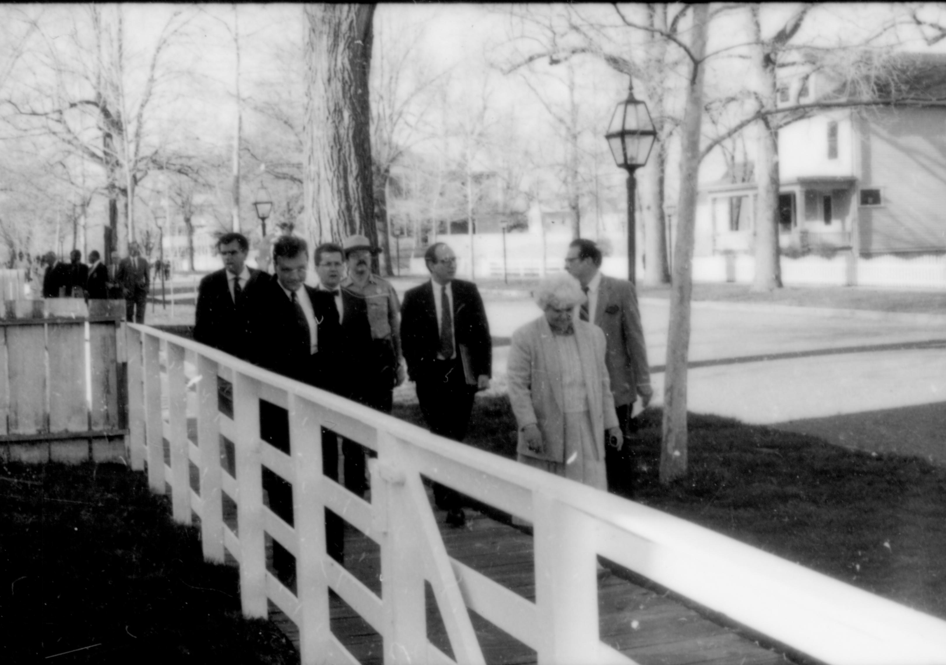 Men and woman walking down board walk. Lincoln Home NHS- Paul Findley and Michel VIP visit, 115 Finley, Michel, tour, visit