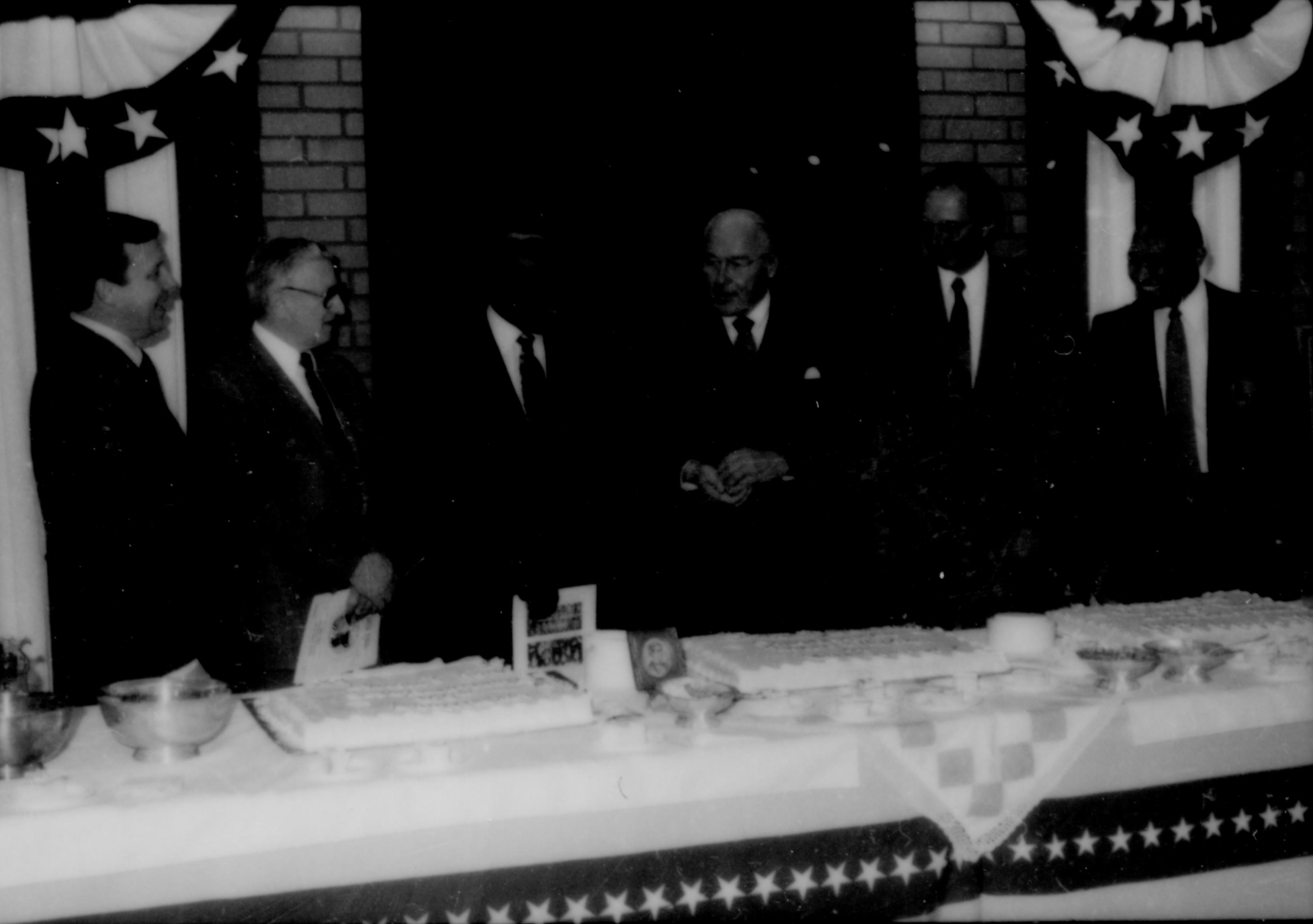 Six men lined up behind table. Lincoln Home NHS- Paul Findley and Michel VIP visit, 119 Finley, Michel, visit, reception