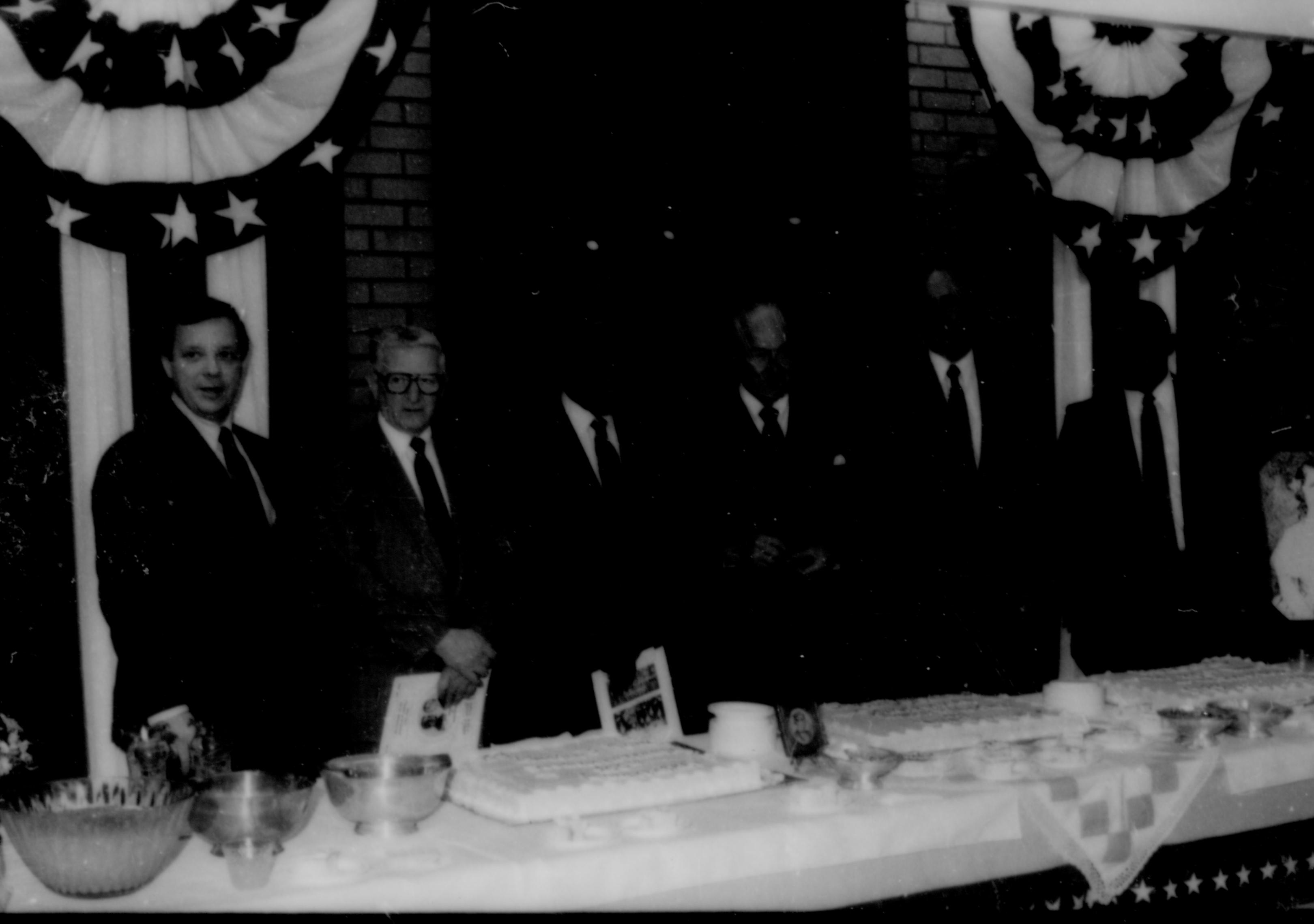 Six men lined up behind table. Lincoln Home NHS- Paul Findley and Michel VIP visit, 119 Finley, Michel, visit, reception