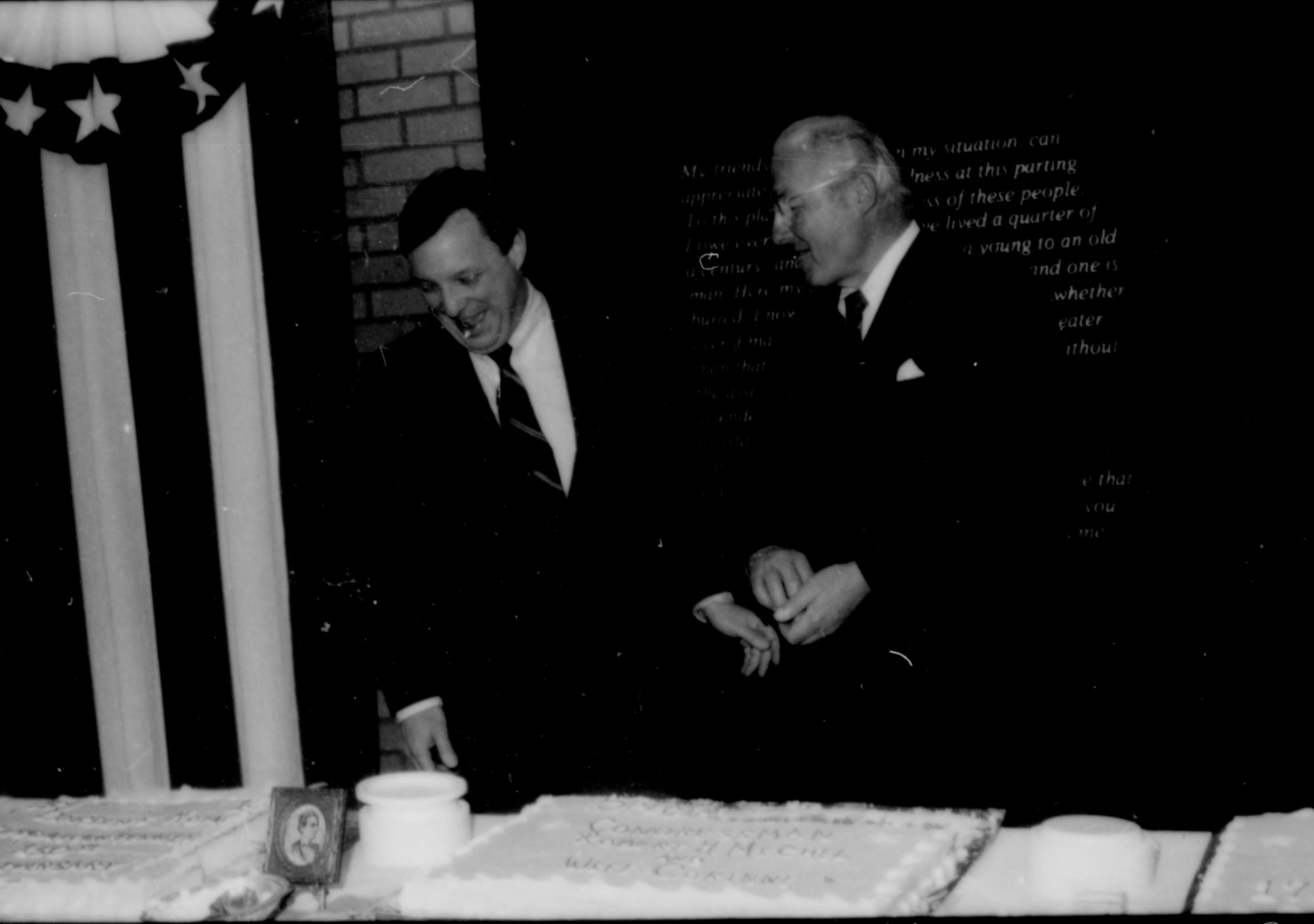 Two men conversing behind table. Lincoln Home NHS- Paul Findley and Michel VIP visit, 119 Finley, Michel, visit, reception