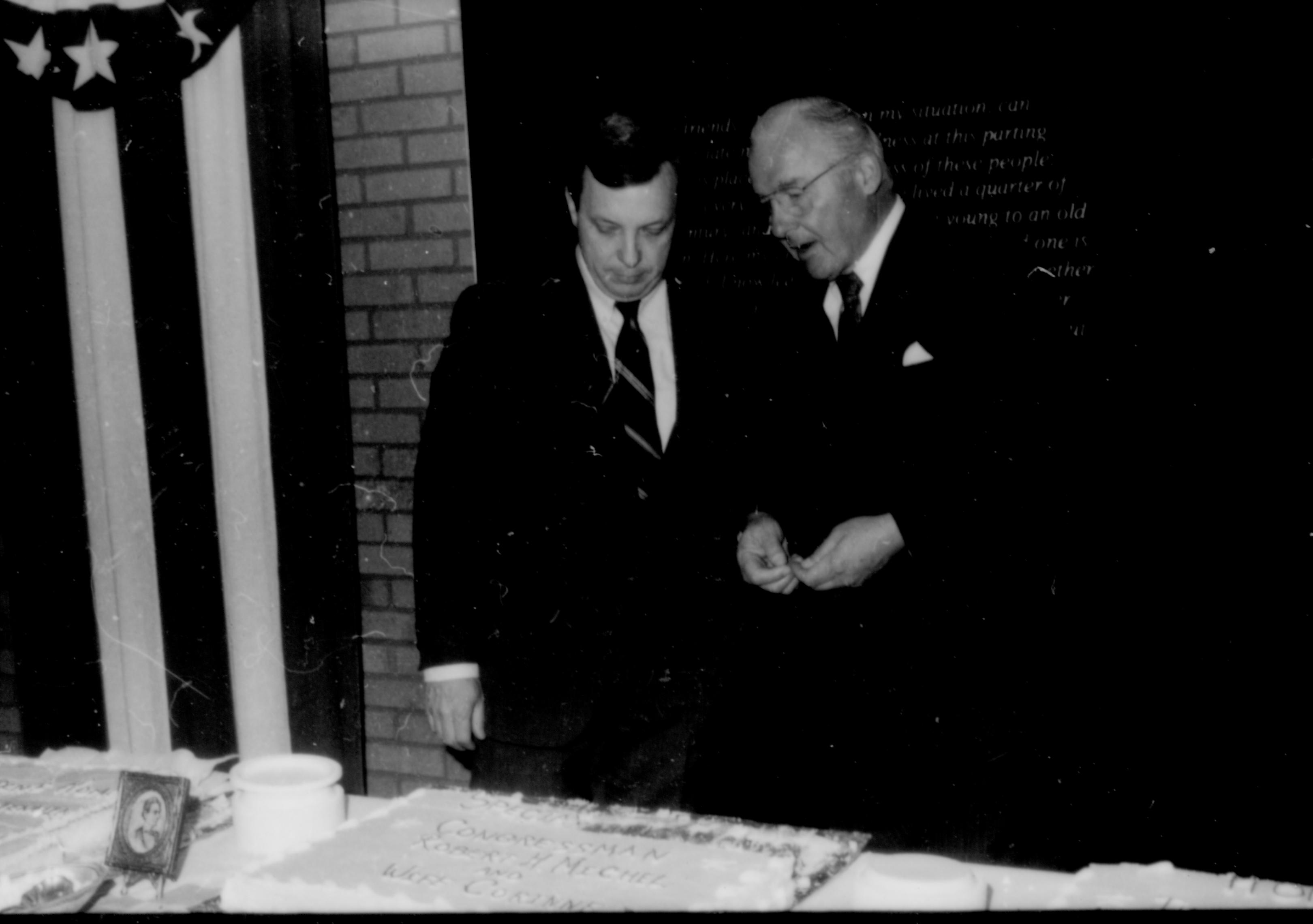 Two men conversing behind table. Lincoln Home NHS- Paul Findley and Michel VIP visit, 119 Finley, Michel, visit, reception