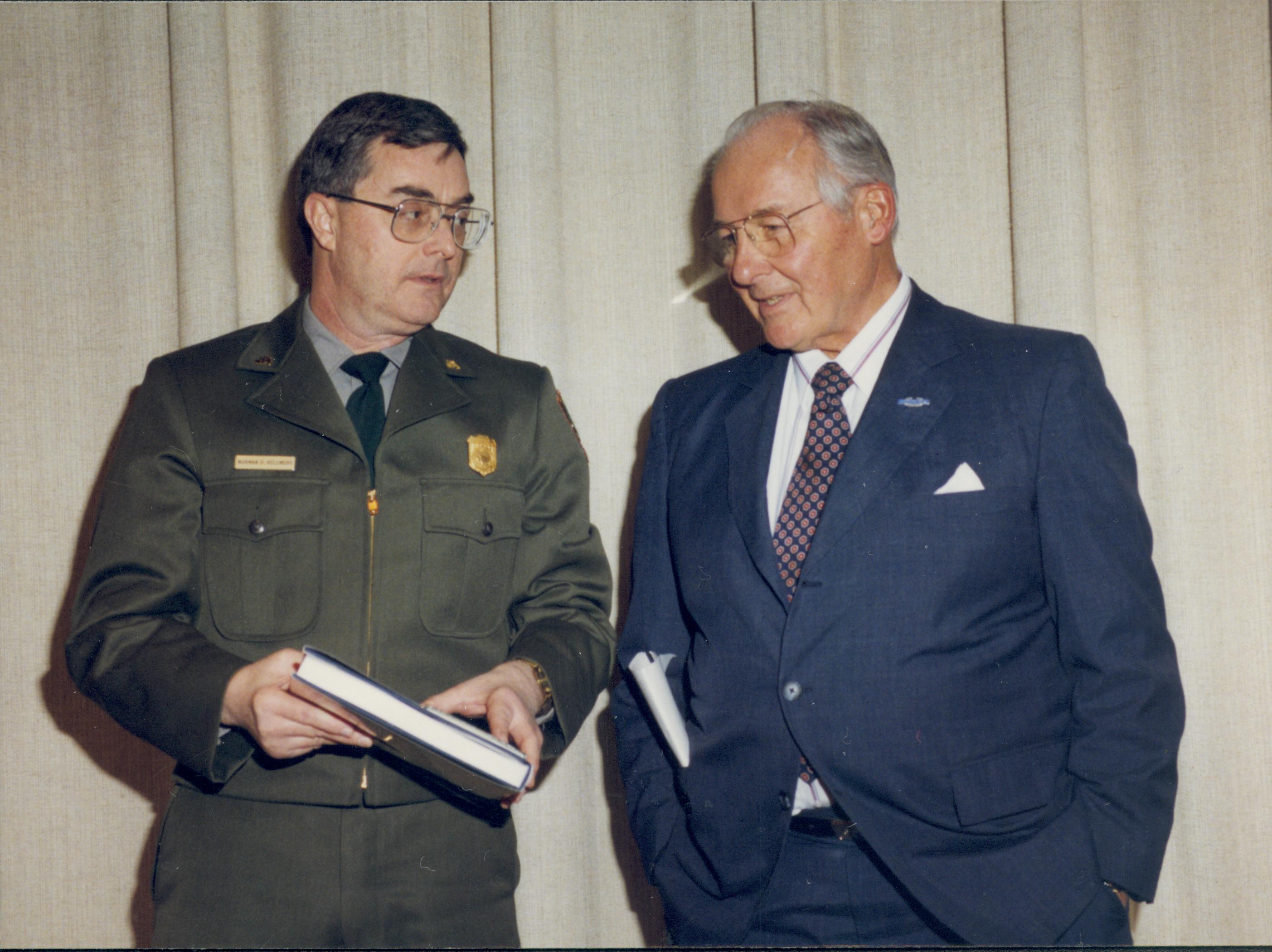 Ranger and man talking in front of curtain. Lincoln Home NHS- VIP Findley and Michel Visit award, visit, tour