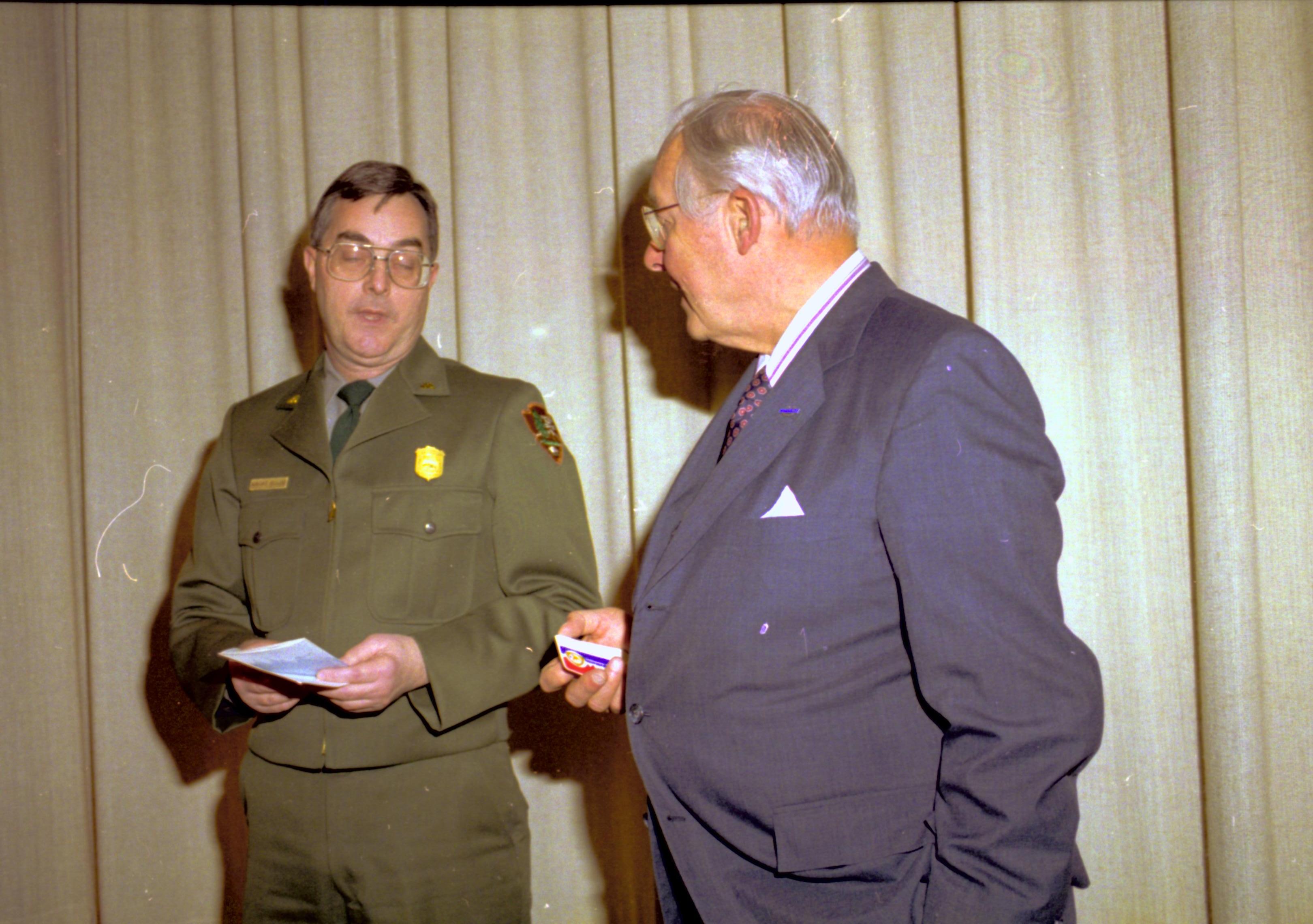 Ranger and man talking in front of curtain. Lincoln Home NHS- VIP Findley and Michel Visit to Lincoln Home visit, program