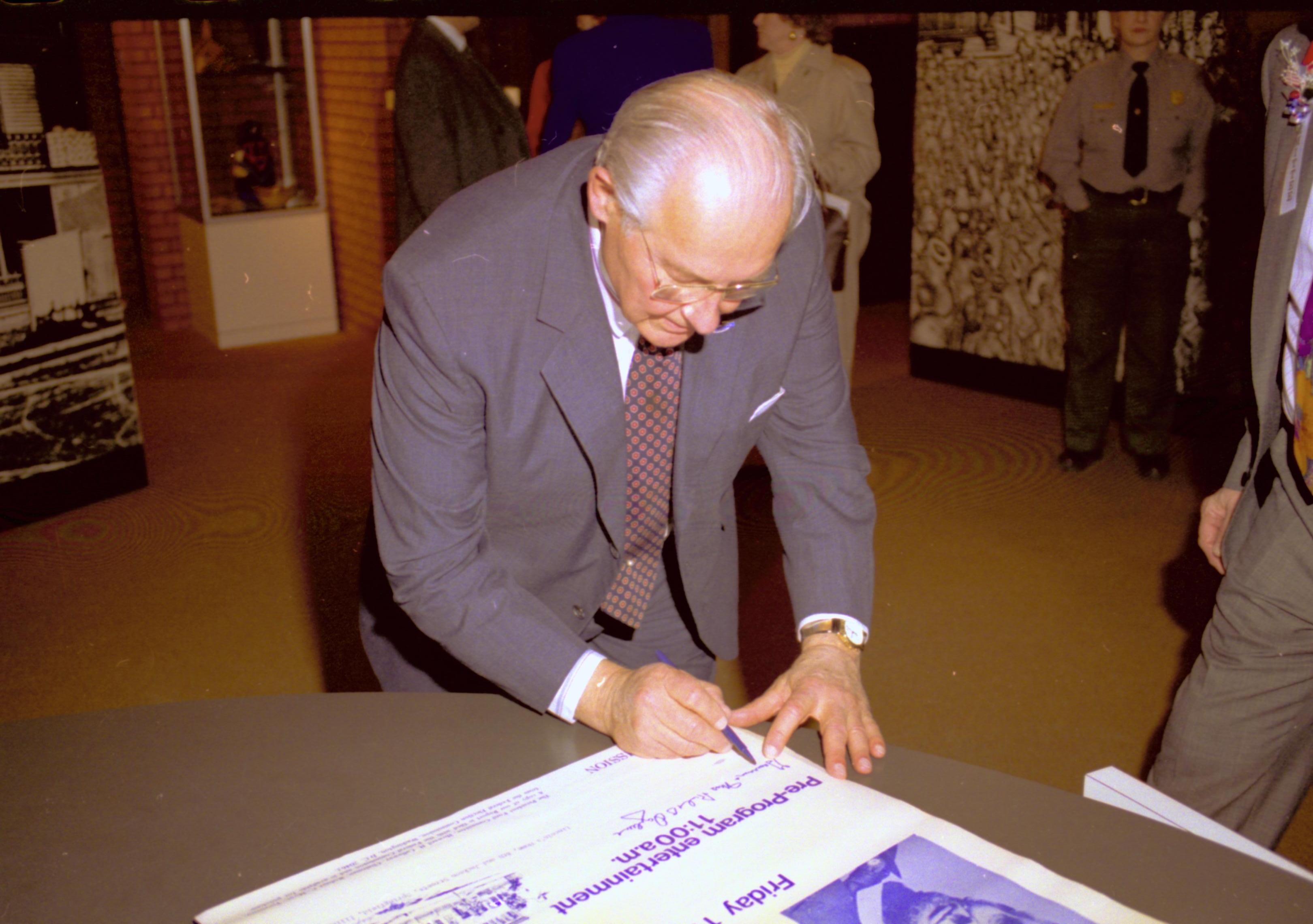 Man signing poster. Lincoln Home NHS- VIP Findley and Michel Visit to Lincoln Home visit, program