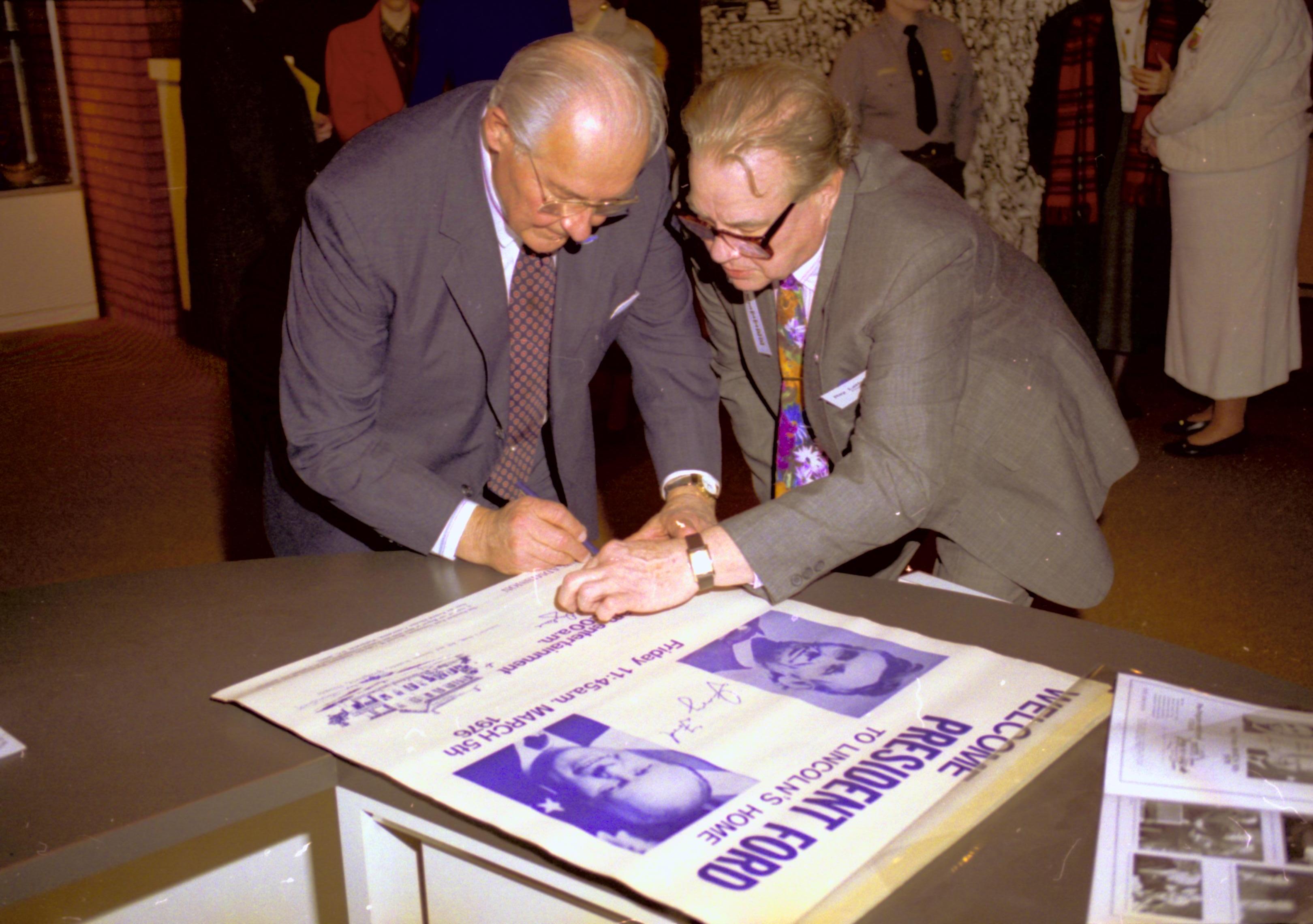 Man signing poster. Lincoln Home NHS- VIP Findley and Michel Visit to Lincoln Home visit, program