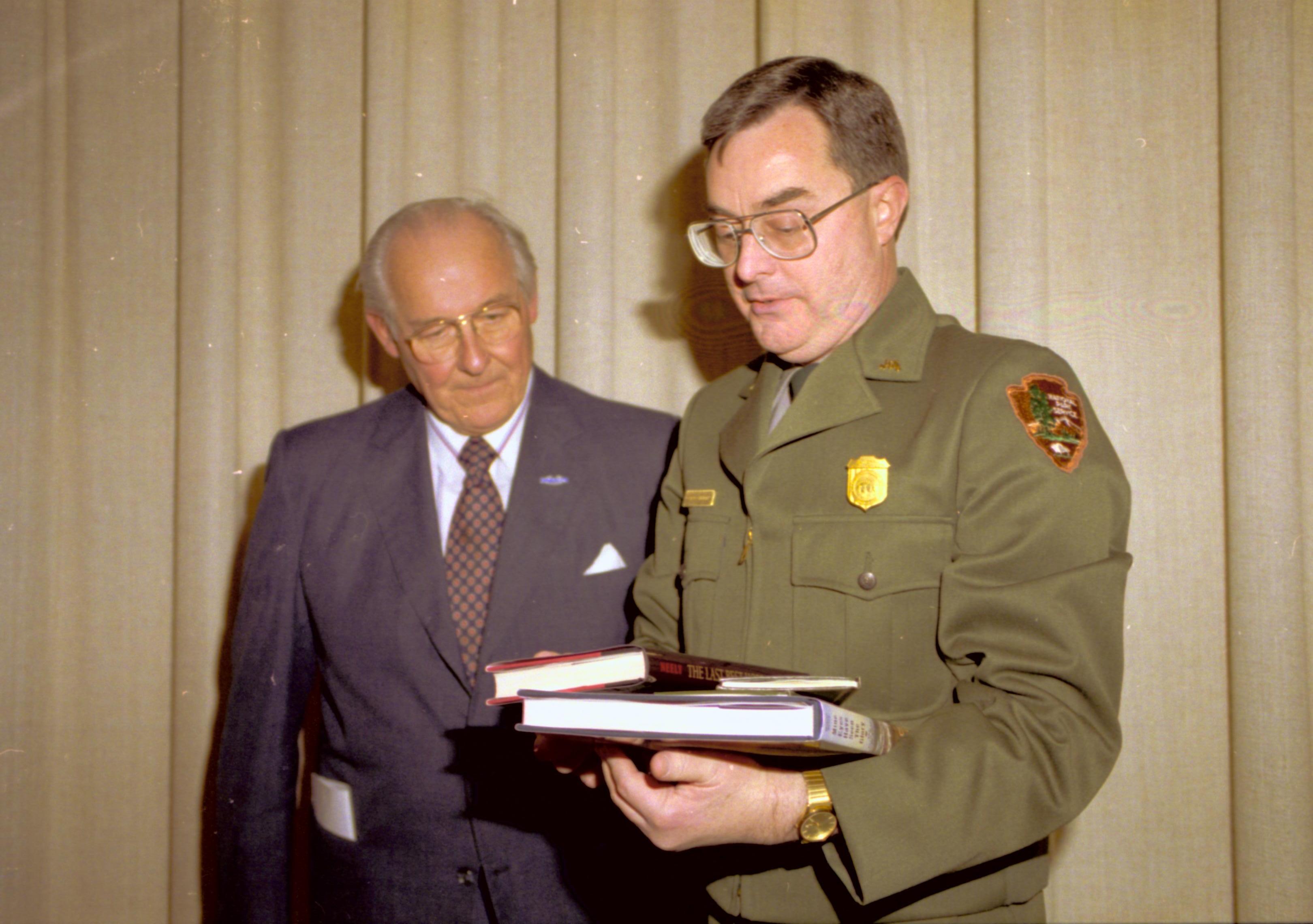 Ranger and man talking in front of curtain. Lincoln Home NHS- VIP Findley and Michel Visit to Lincoln Home visit, program