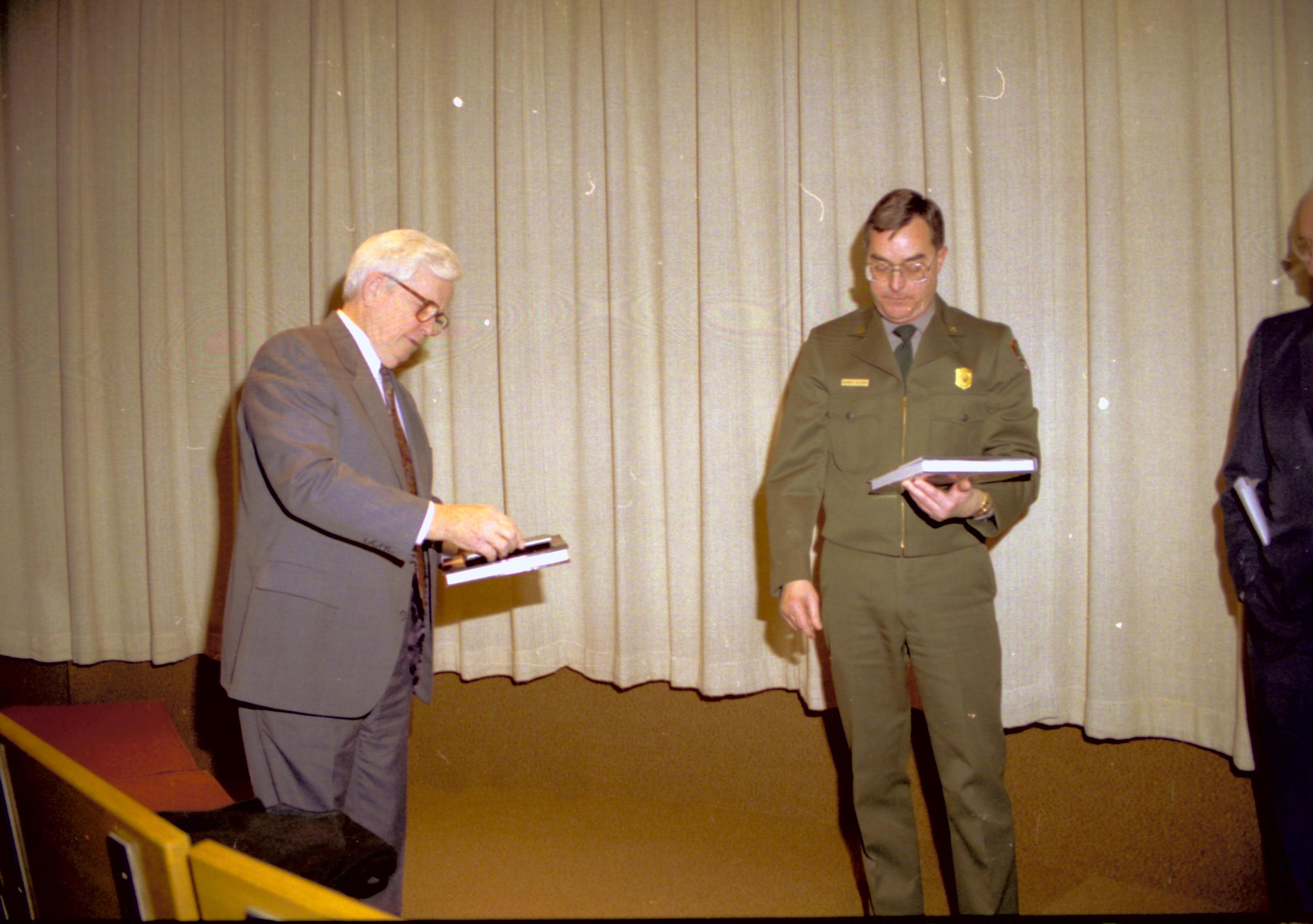 Man and ranger holding books. Lincoln Home NHS- VIP Findley and Michel Visit to Lincoln Home visit, program