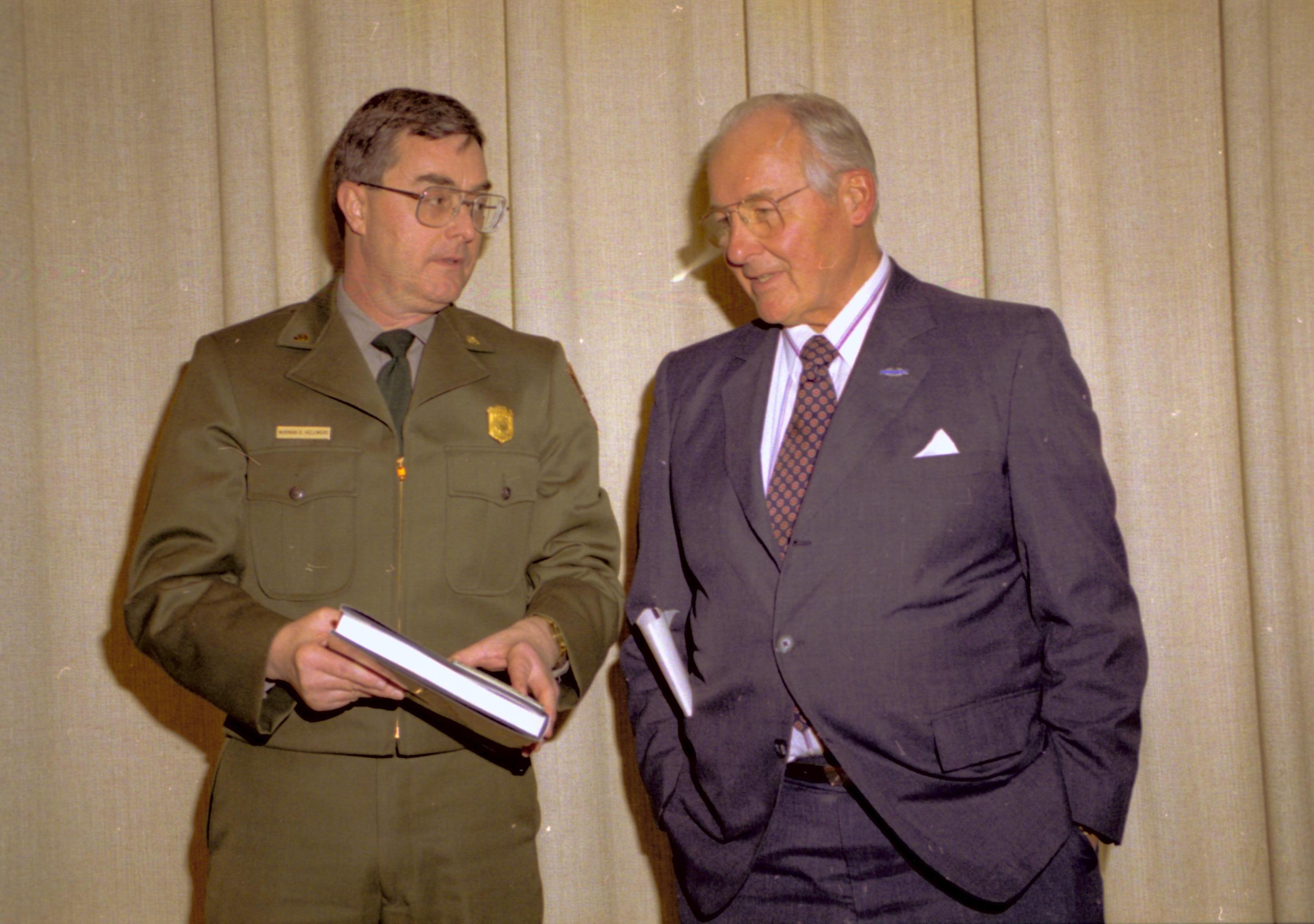 Ranger and man talking in front of curtain. Lincoln Home NHS- VIP Findley and Michel Visit to Lincoln Home visit, program