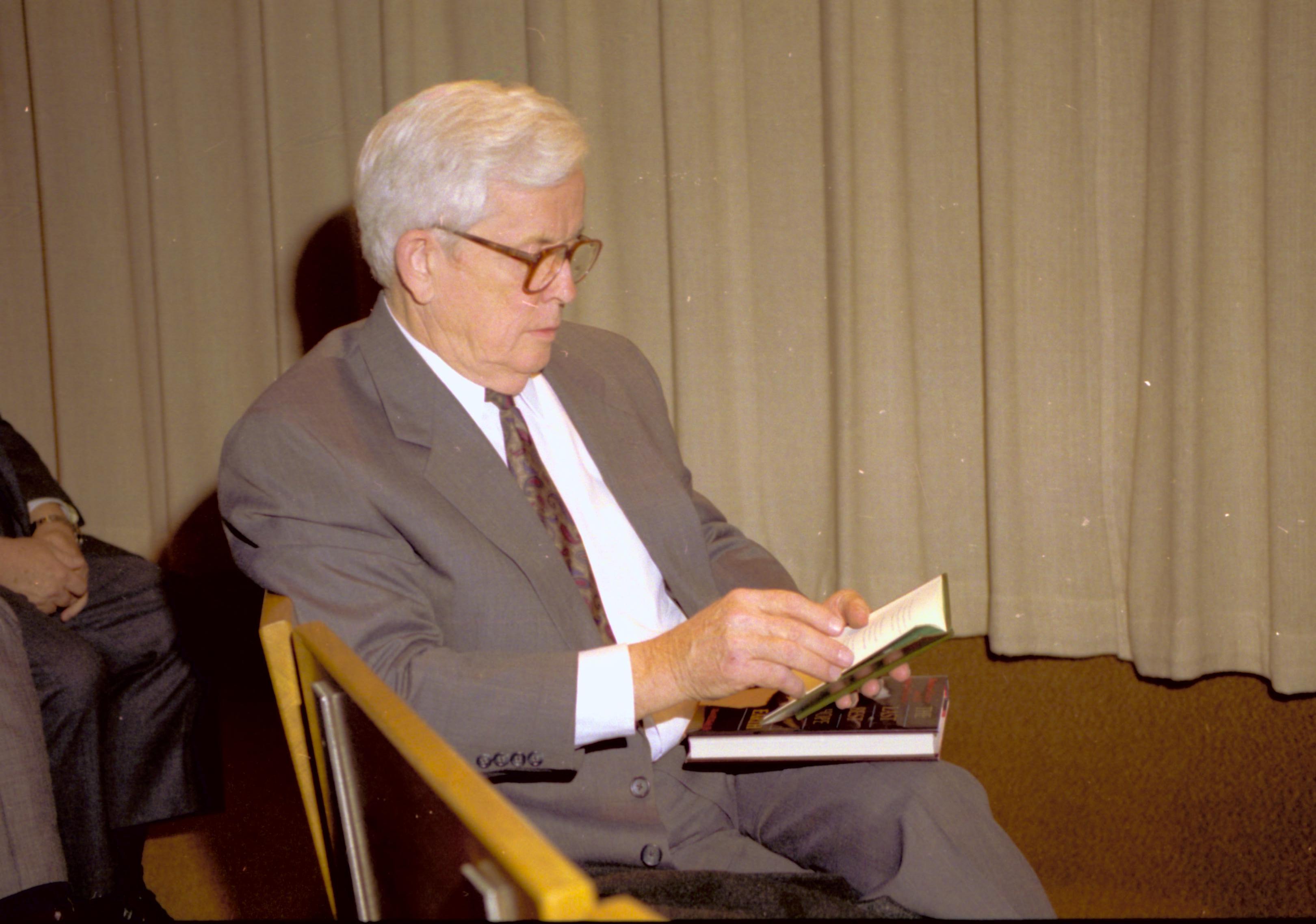 Man seated reading booklet. Lincoln Home NHS- VIP Findley and Michel Visit to Lincoln Home visit, program