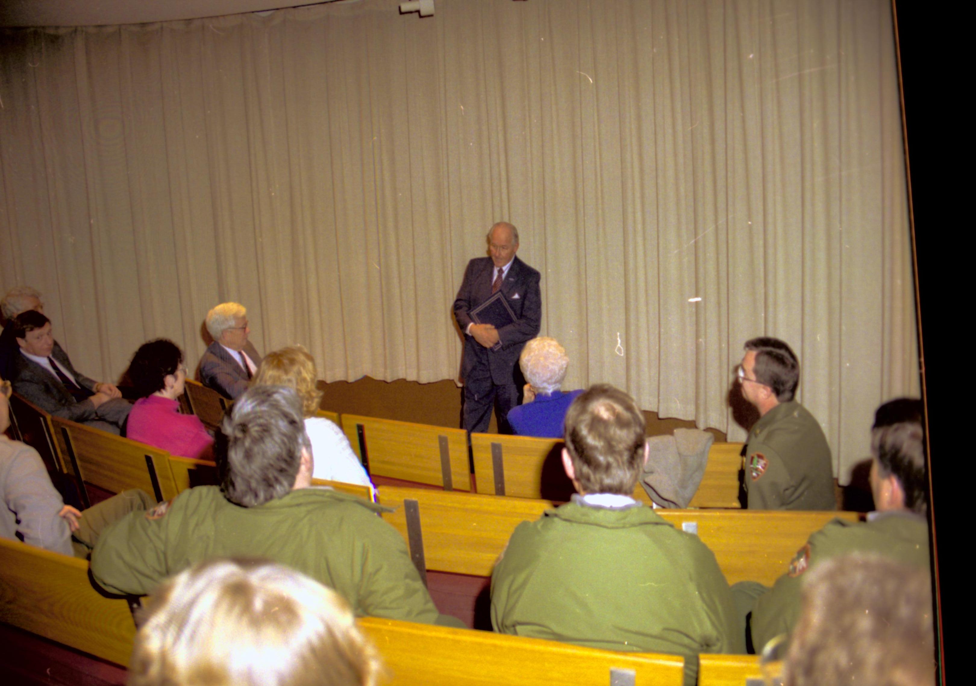 People sitting on benches in theater listening to speaker. Lincoln Home NHS- VIP Findley and Michel Visit to Lincoln Home visit, program