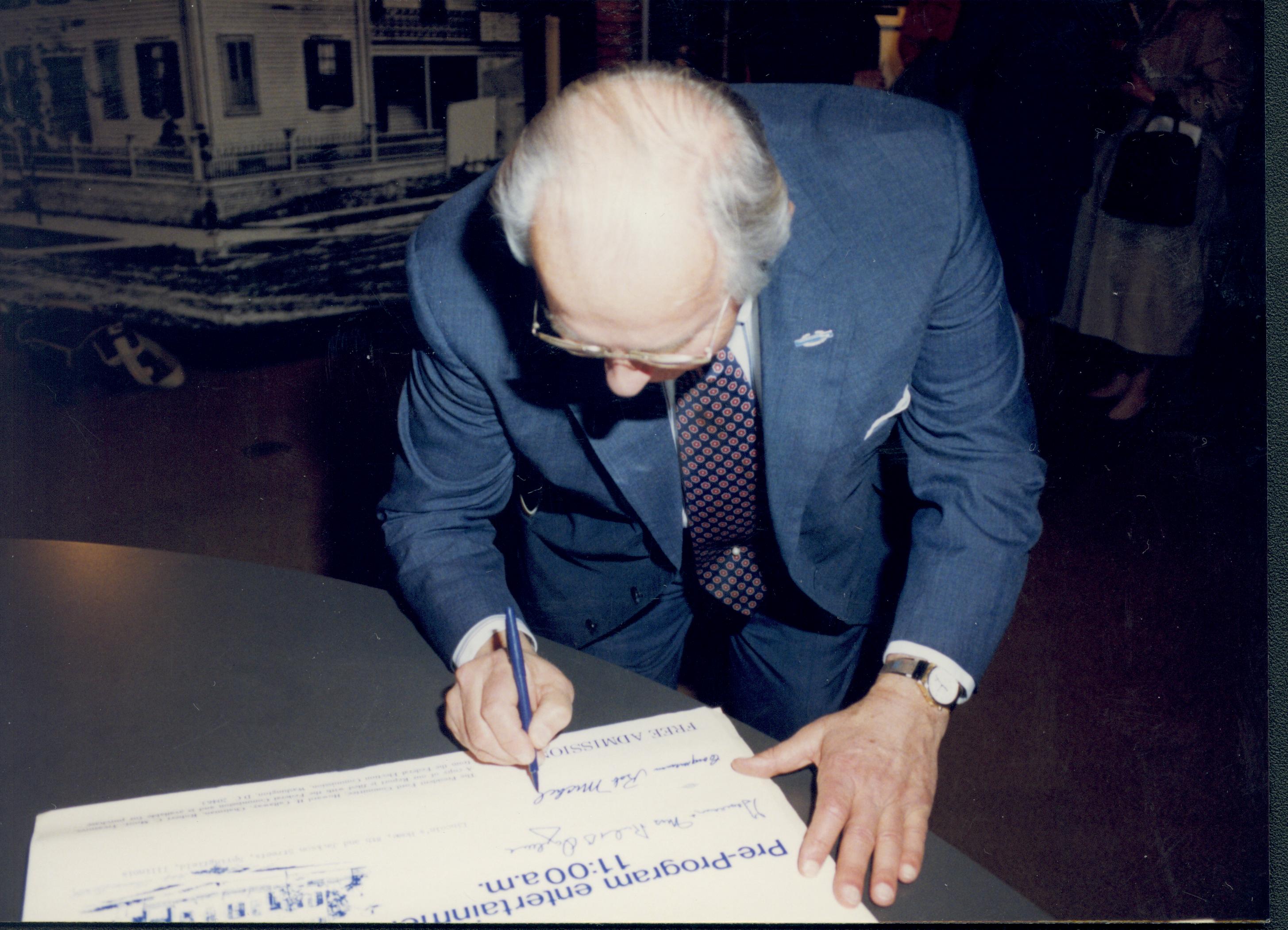 Man signing poster. Lincoln Home NHS- VIP Findley and Michel Visit visit, program