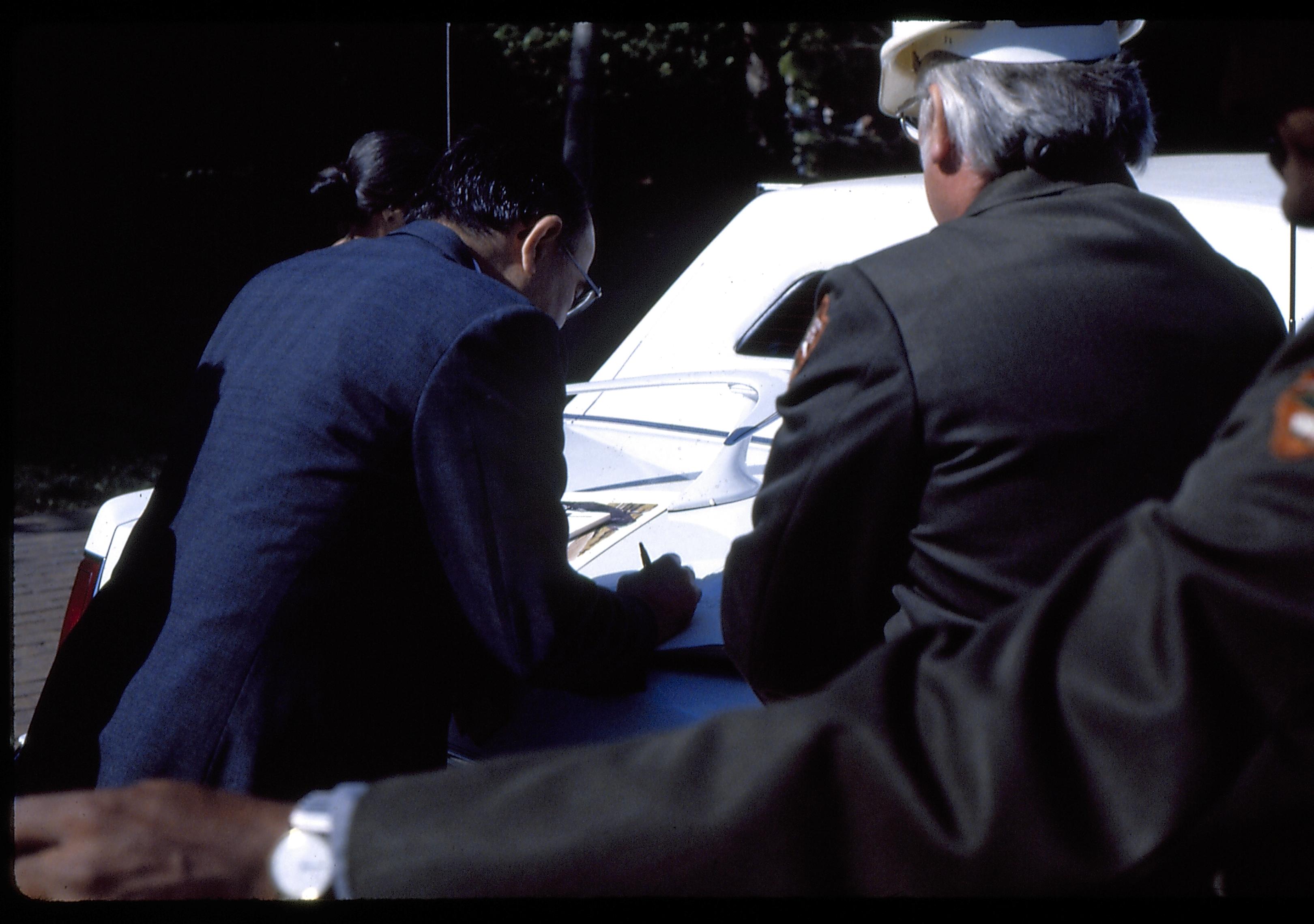 Man writing using trunk of car as desk. Lincoln Home NHS- Foreign Dignitary Visit dignitary, visit, tour