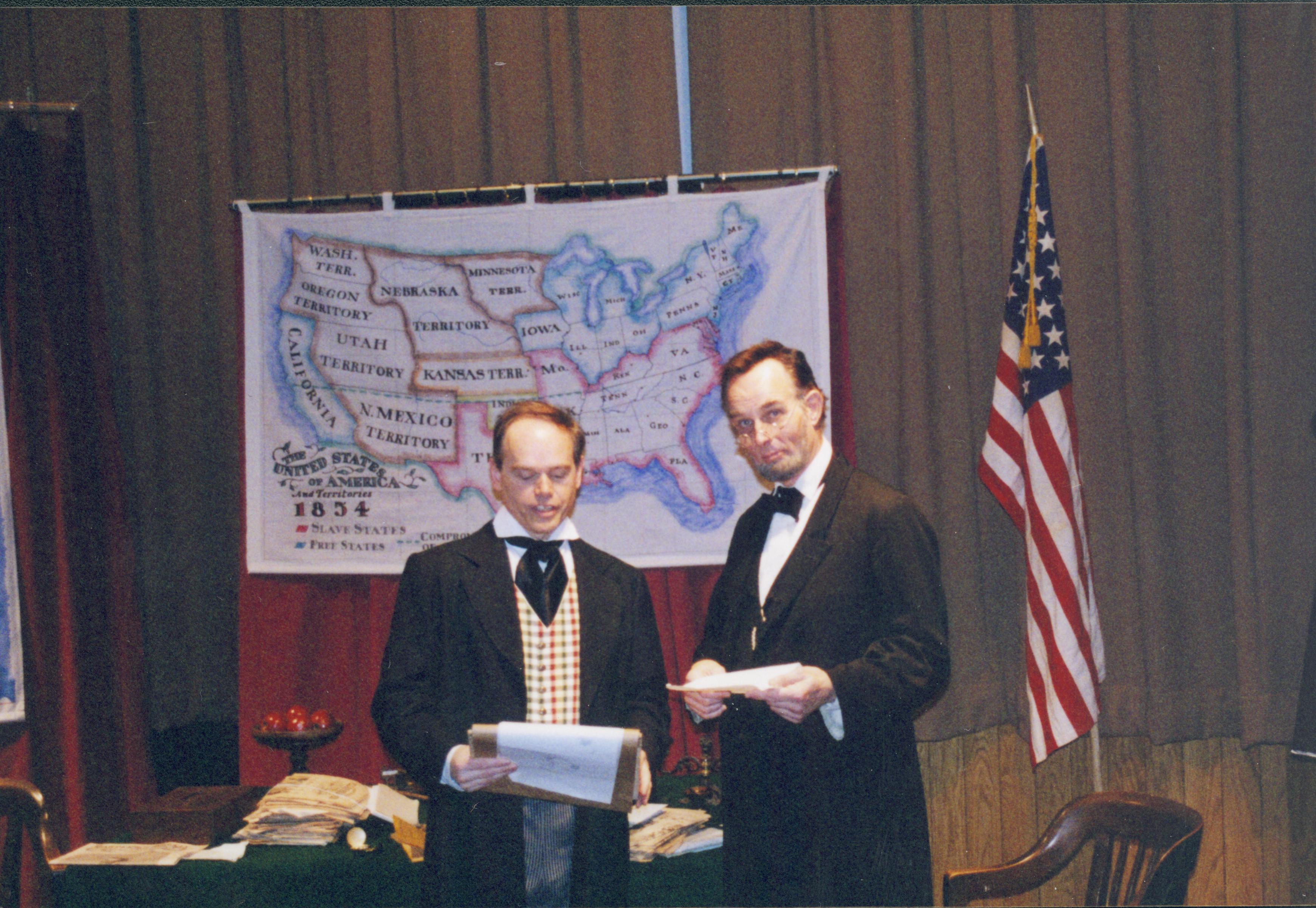 Two men in period dress standing in front of U.S. map. Lincoln Home NHS- Fritz Klein and Drew Gibson visit, roll 2002-1, exp 16 Klein, Gibson, visit