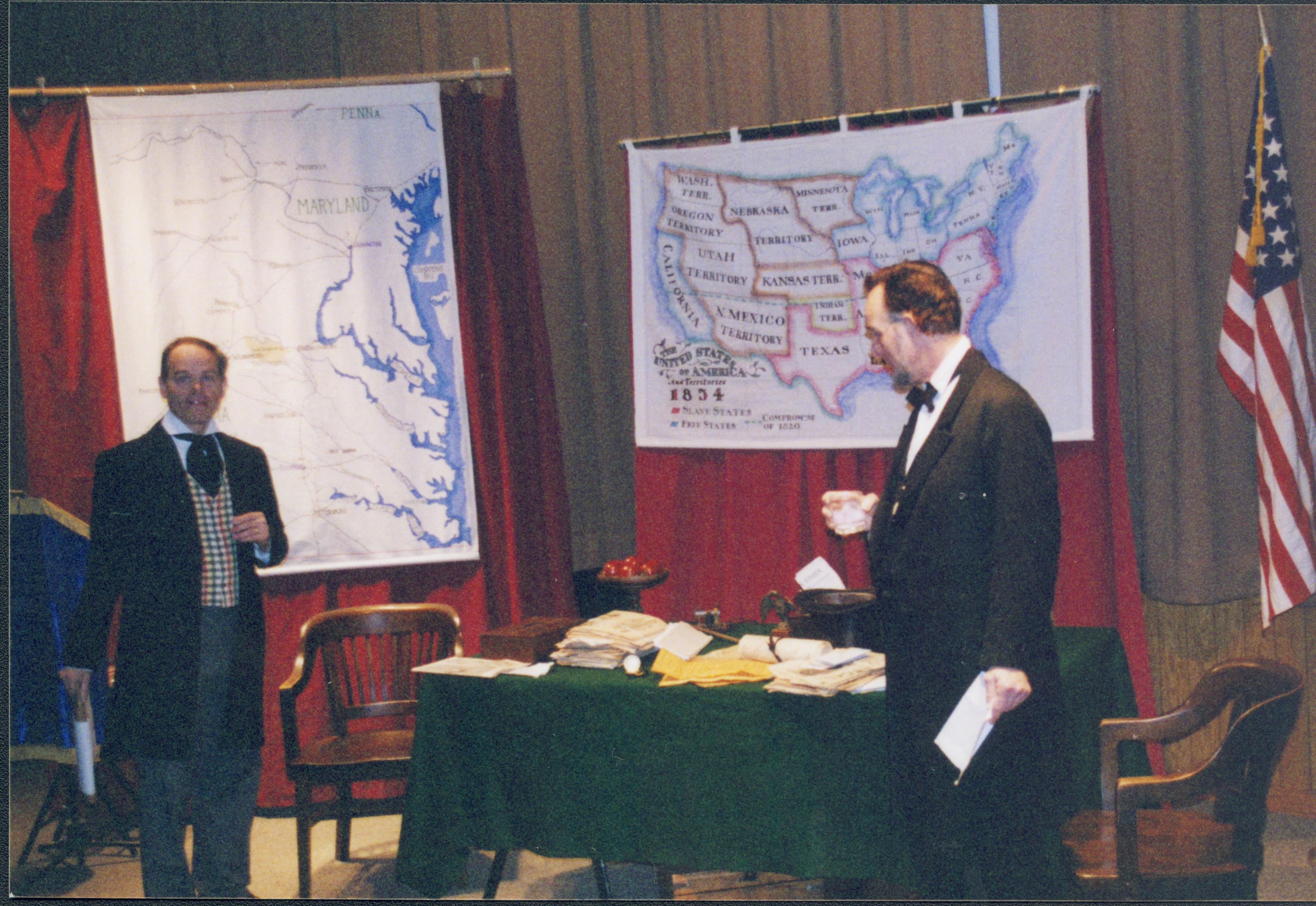 Fritz Klein takes a drink while Drew Gibson talks Lincoln Home NHS- Fritz Klein and Drew Gibson visit, roll 2002-1, exp 17 Klein, Gibson, visit